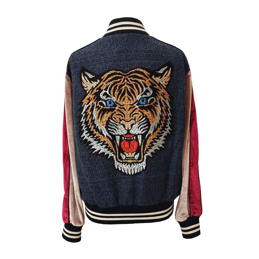 Polyester (92%) and elasthane Multicolor Embroidered tiger on back Zip closure Two pockets Length shoulder/hem cm 55 (21,65 inches)