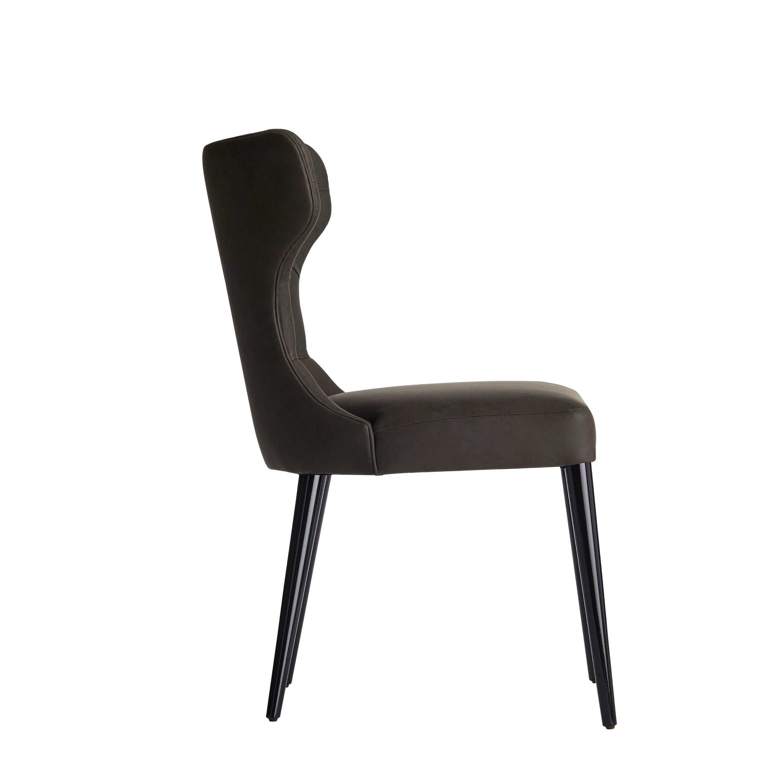 FORTUNA is a dining chair with a well-balanced design, with an enveloping back, which gives a feeling of extreme comfort, characterized by the elegant tufted details.‎ The legs are lacquered, available in a range of colours, with matt or glossy