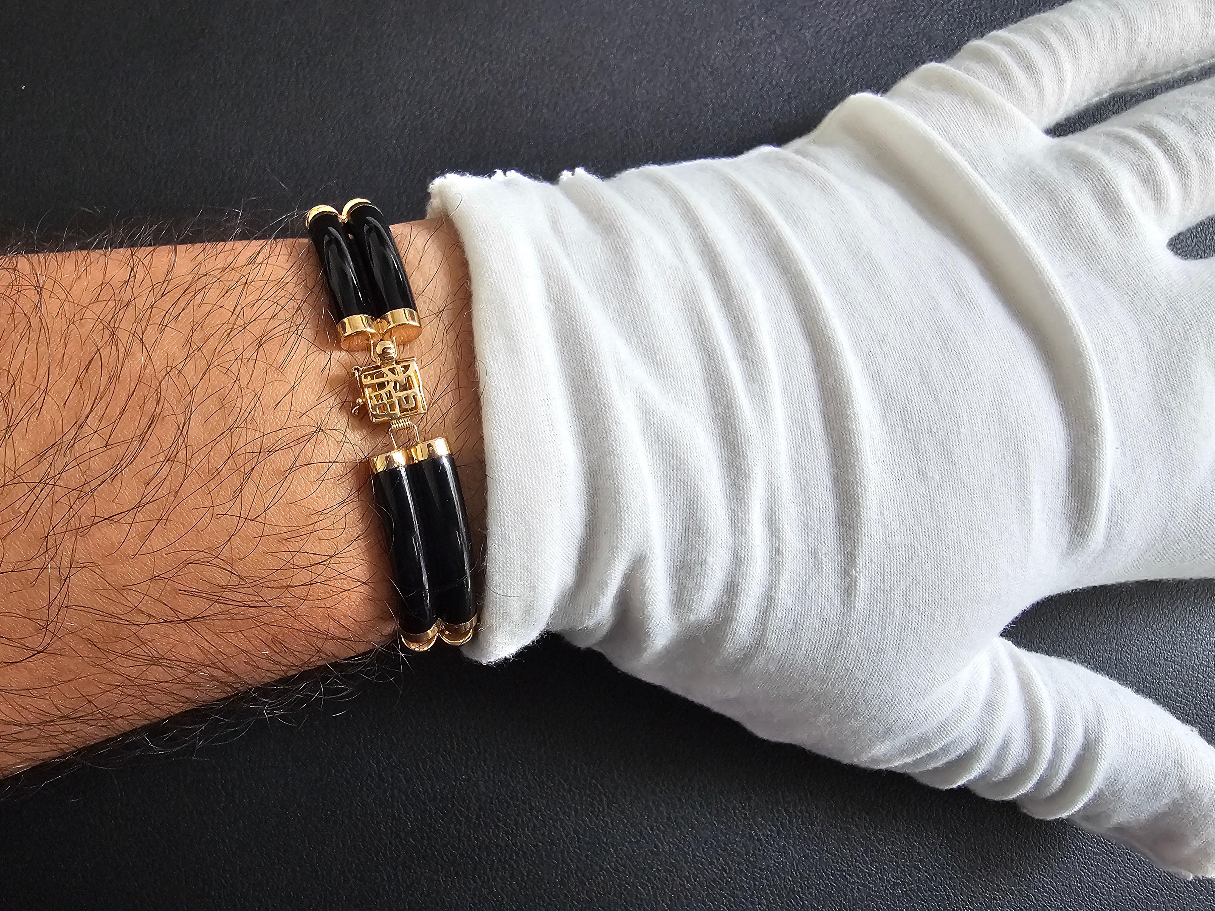 Fortune Onyx Bracelet Double Bars with 14K Solid Yellow Gold links and clasp

Our 'Double Fu Fuku Fortune Onyx Bracelet' embodies radiance and stature, with hand carved black onyx lengths intertwined with 14K Gold; a unisex statement. The two layers