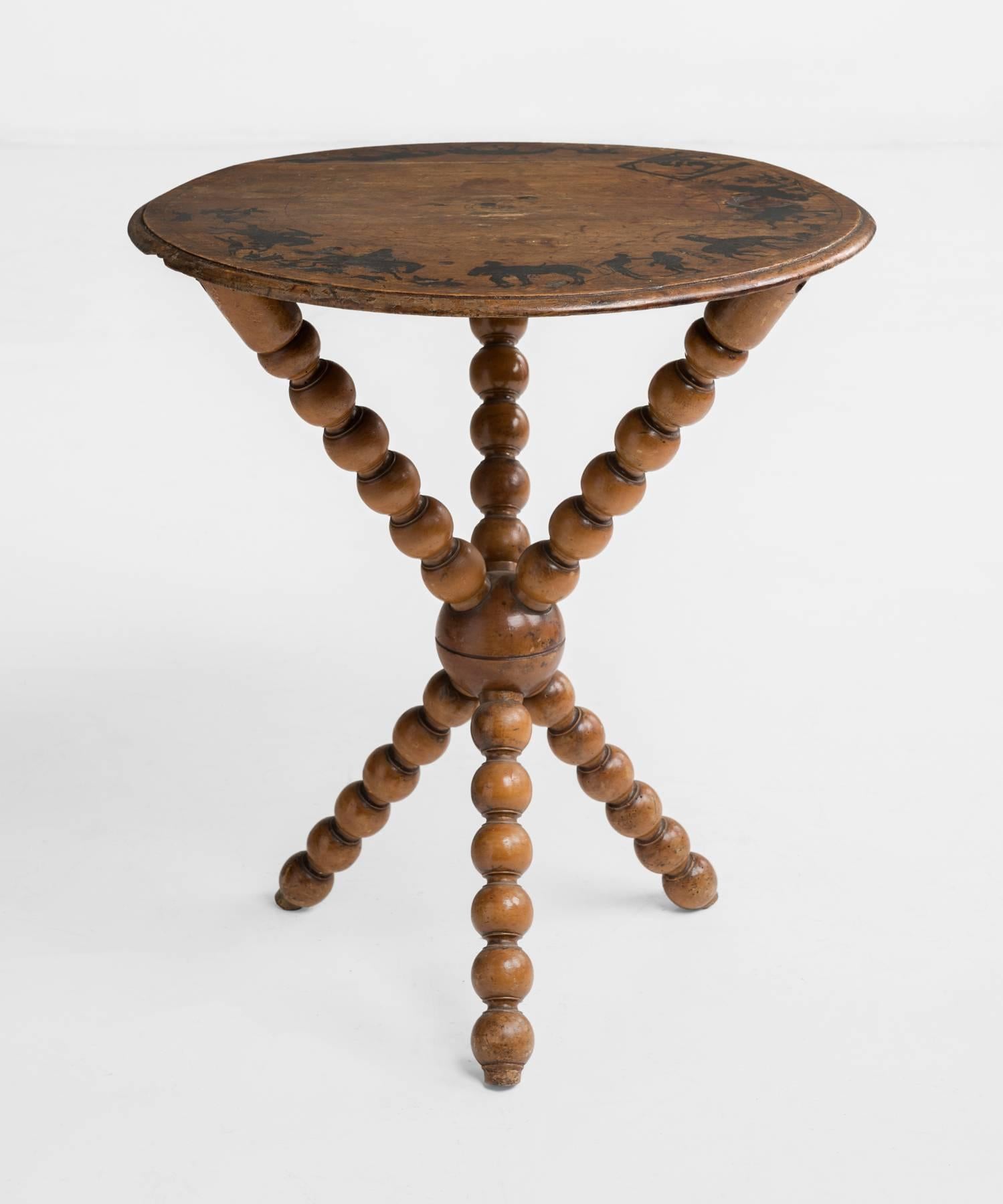 Fortune tellers table, circa 1830.

Gypsy fortune tellers table, with incredible ink drawings and symbols on mahogany surface and unique bobbin base.
 