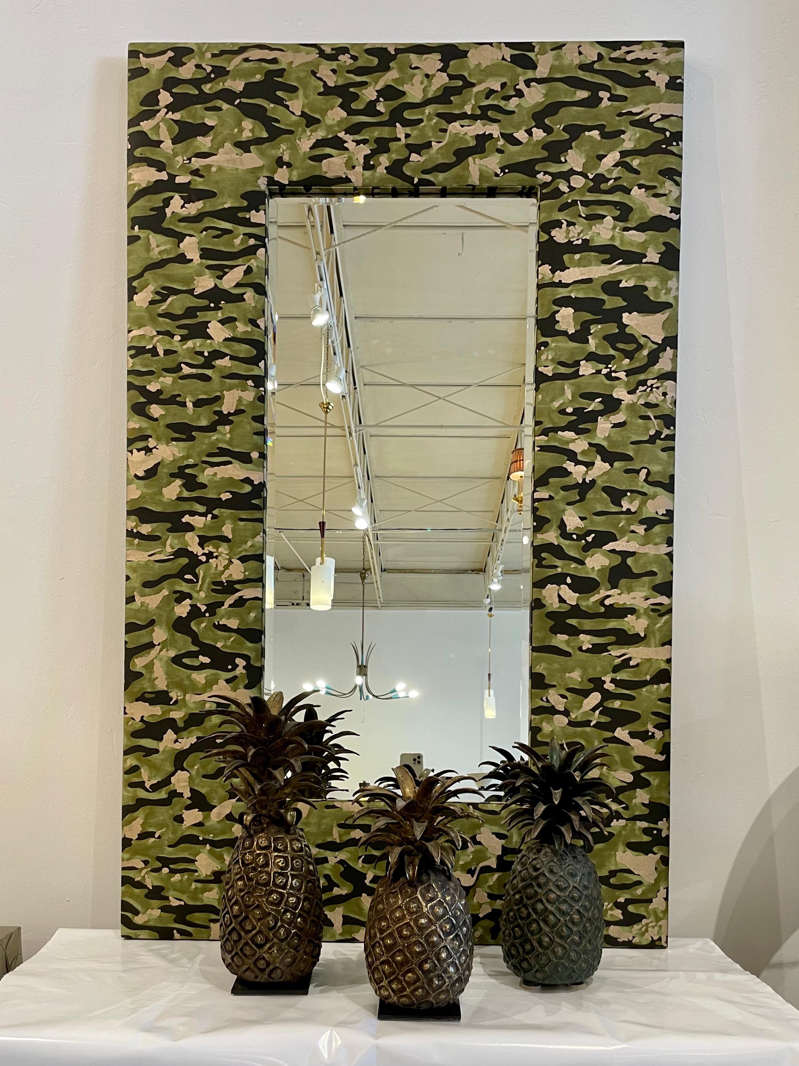 An amazing custom wall mirror in Fortuny cotton fabric and beveled mirror.

This cotton fabric is a Venetian interpretation of traditional camouflage, Fortuny’'s Camo pattern is created from photographs of water and islands as opposed to foliage.