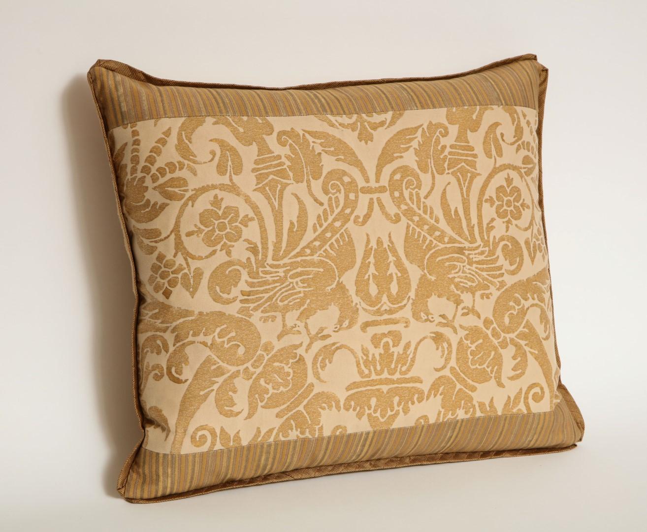 A Fortuny fabric lumbar cushion in the Uccelli pattern, antique yellow and monotones, silk blend backing material and silk bias edging, the pattern, a 17th century French design with bird motif. 

Newly made.

50 down/50 feather insert.