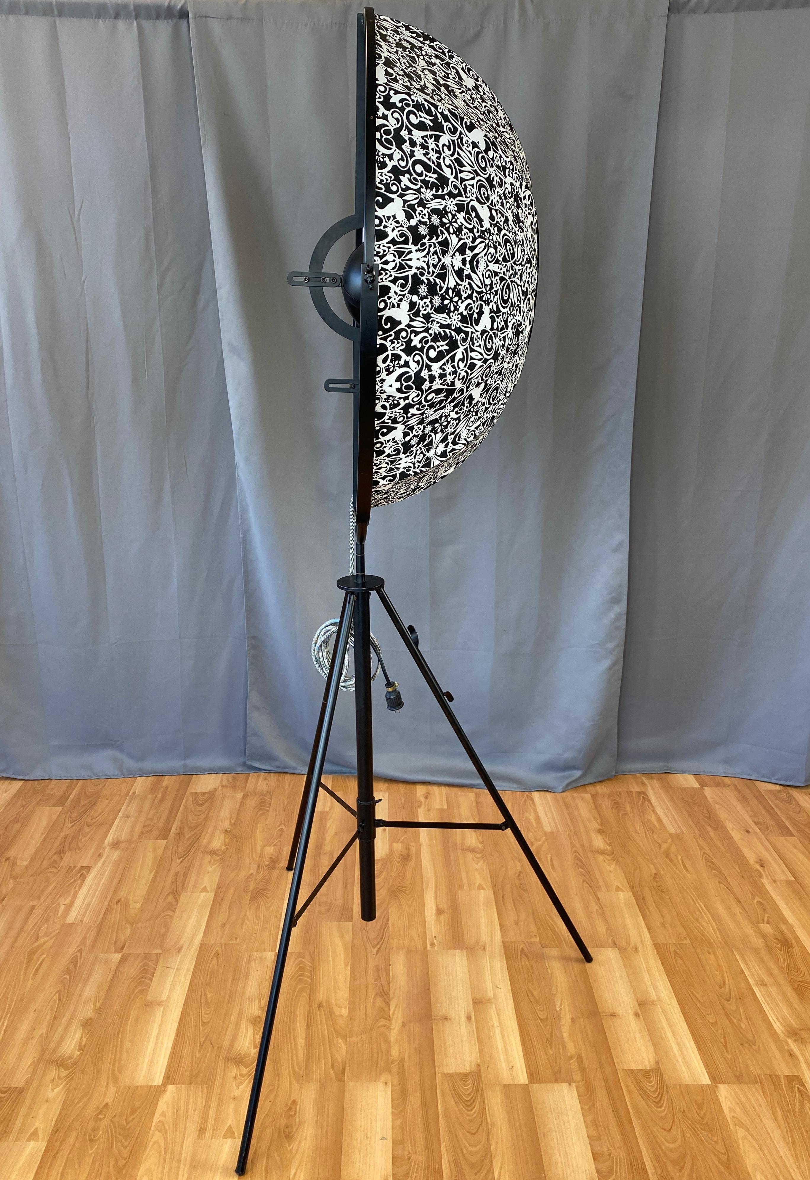 Designed by Mariano Fortuny y Madrazo in 1907. This one is circa 2004, and was made by Pallucco in Italy

First designed for stage lighting/new indirect lighting system for the stage. With its base coming from an idea of using a camera's tripod,