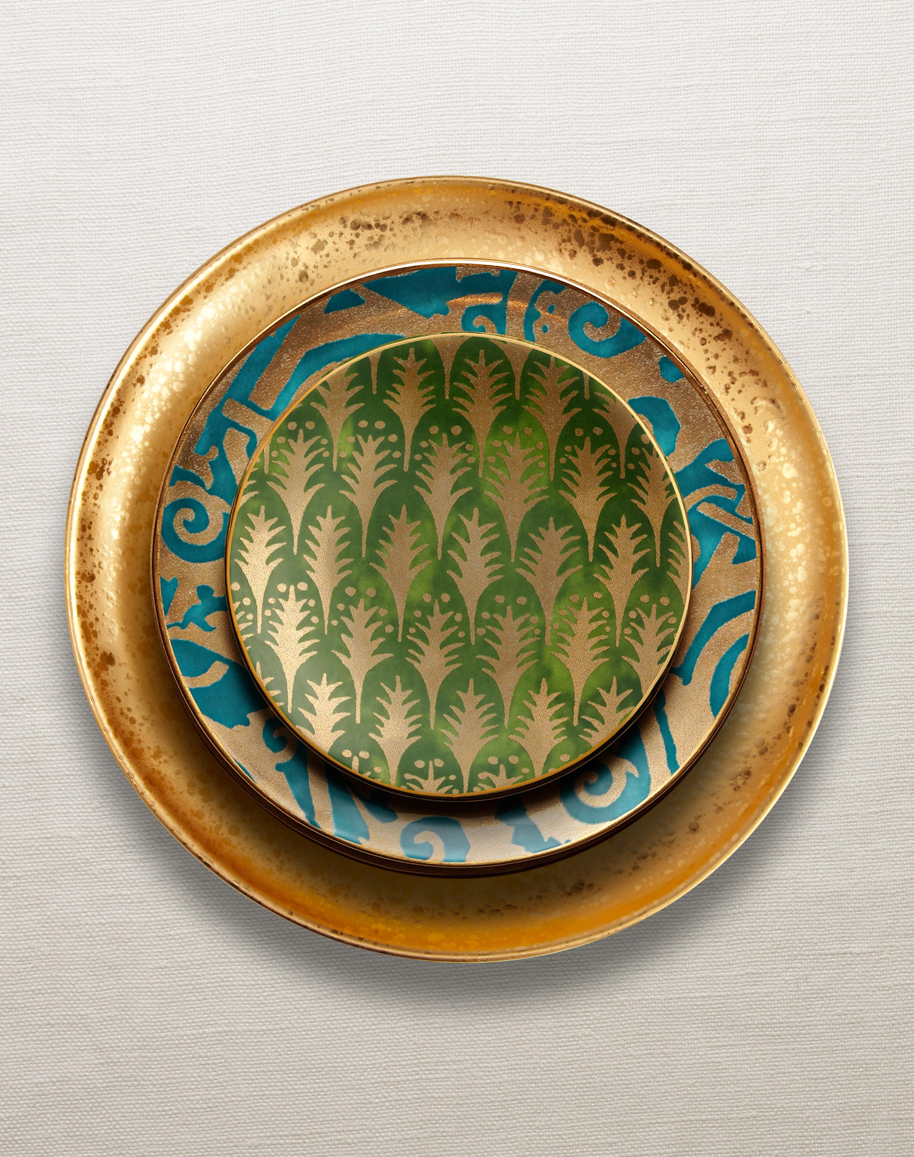 The artisans of Venice inspire us with their way of being- a sumptuous tapestry of invention and delight, woven throughout everyday experiences. This vibrant set of 4 canape plates is hand-crafted from earthenware with hand-gilded 24K gold