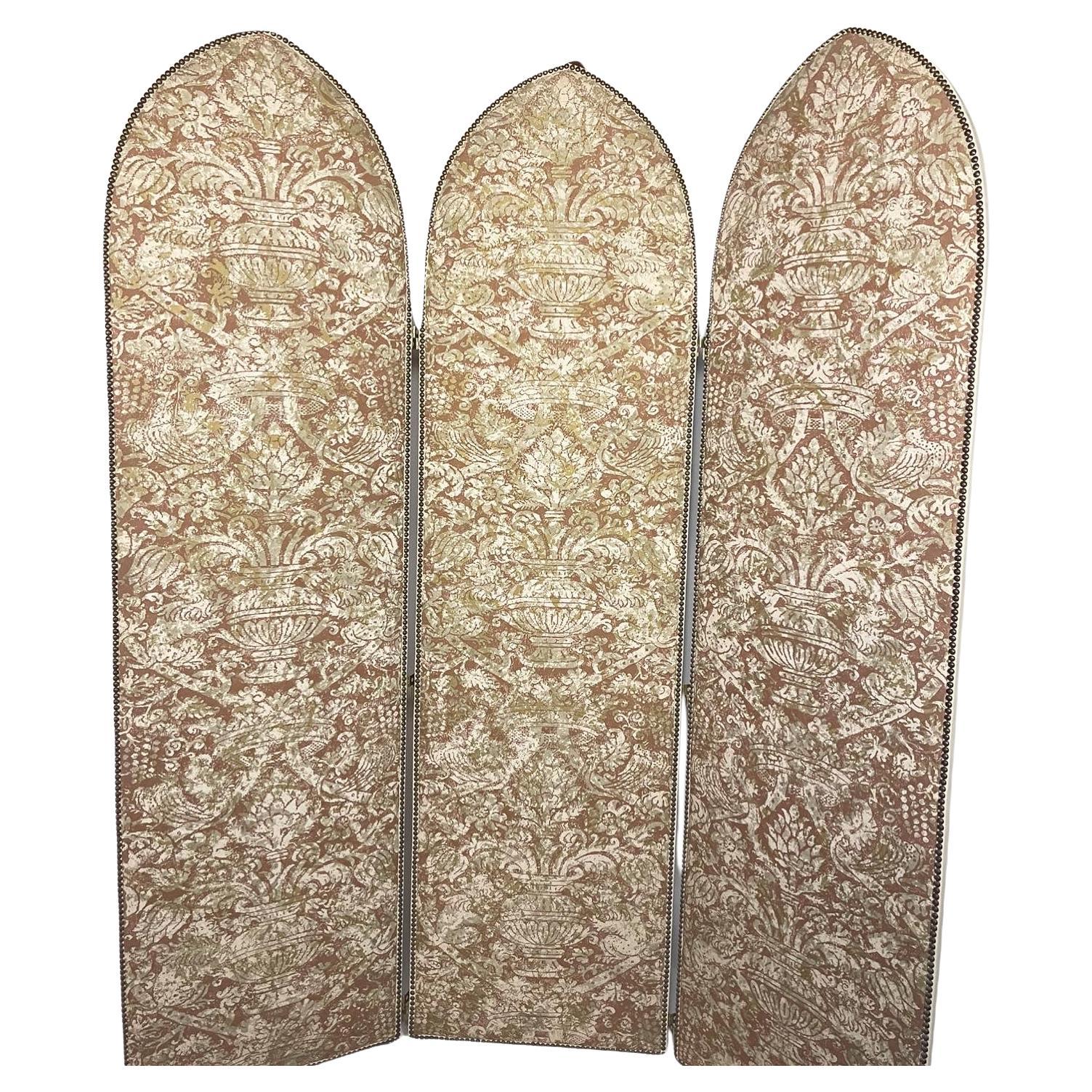 Beautiful Fortuny damask and leather folding screen in beige and gold with white leather and nailhead trim from the estate of William Goldman (1931-2018) British, novelist, playwright, and poet. The 3 paneled folding screen measures 85 inches high