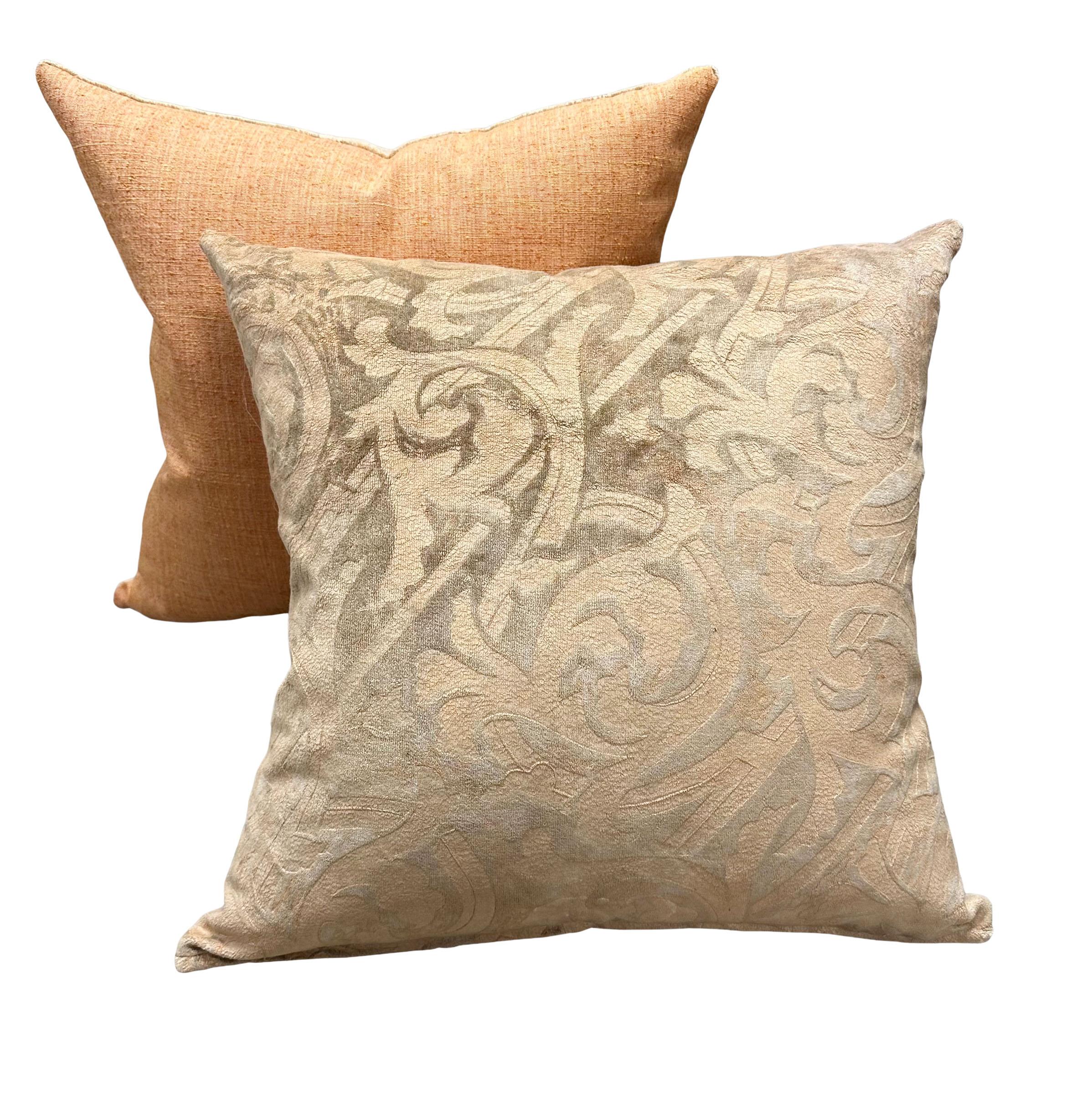 An elegant pair of printed silver and peach Fortuny silk and cotton velvet fabric pillows. The back is a vintage knobby linen silk and the interiors are down filled. These do not have any piping or trim so they have more of a modern look but are