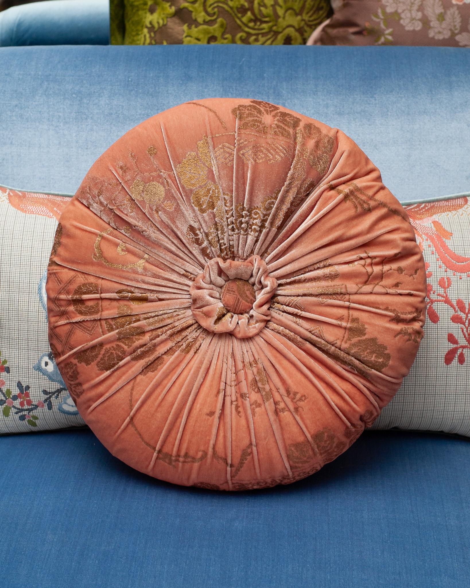 A beautiful Fortuny / Venetia Stadium round pillow with pleats and a center tuft in soft pink velvet with gold, made in Venice.

Mario Fortuny was born in 1871 in Granada Spain and after a childhood marked by the premature death of his father he