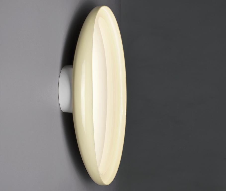 A wall lamp with a diffused, reflected light. The diffuser is made of liquid varnished injection molded ABS. The white epoxy powder varnished wall mount in die-cast steel acts as a heat sink for the LED board. The LEDs are directly powered without
