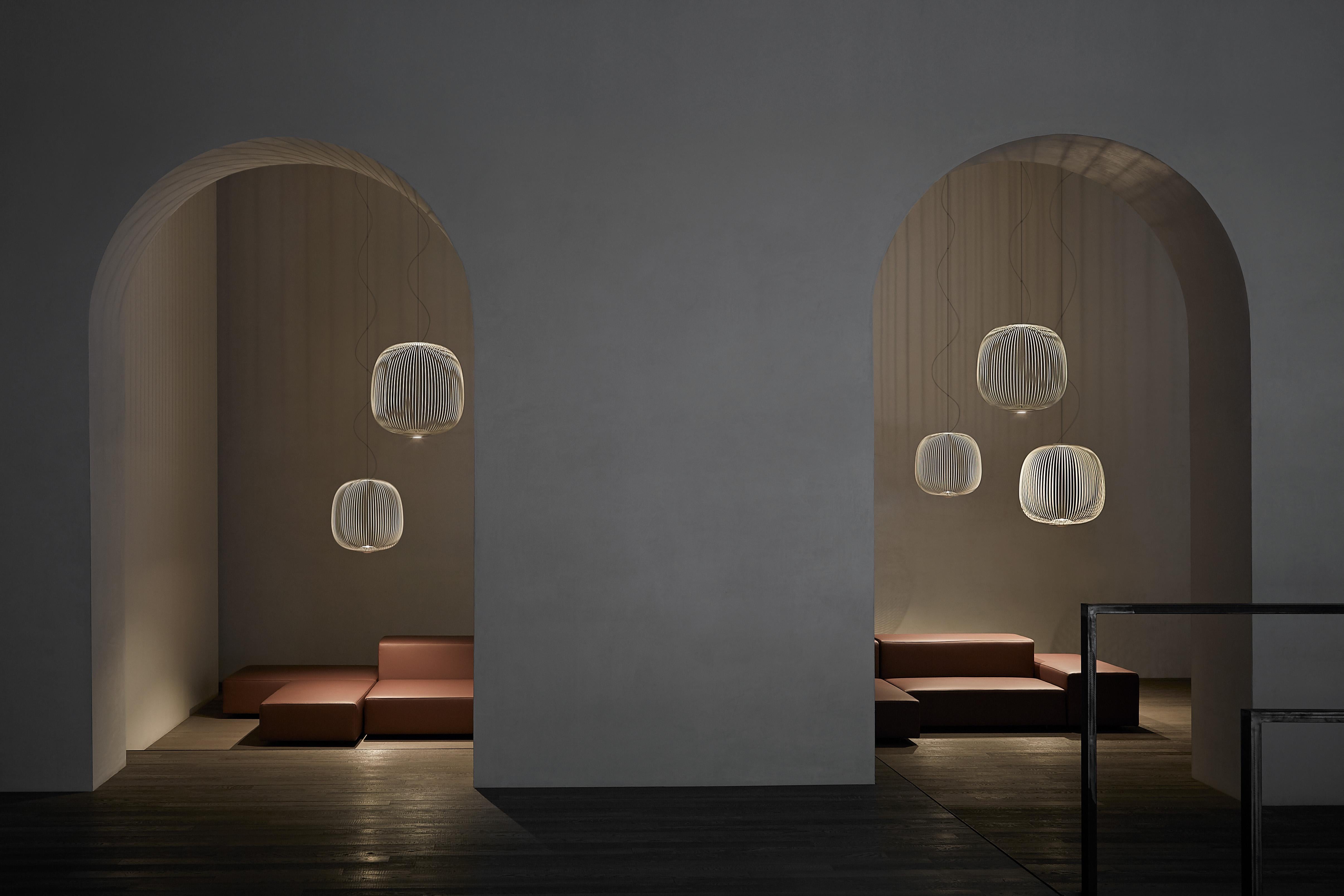 A collection of suspension lamps with two different shapes. The opaque epoxy powder varnished steel spokes are attached to the upper part by two ABS/polycarbonate discs and to the lower part of the aluminum module that acts as the housing and heat