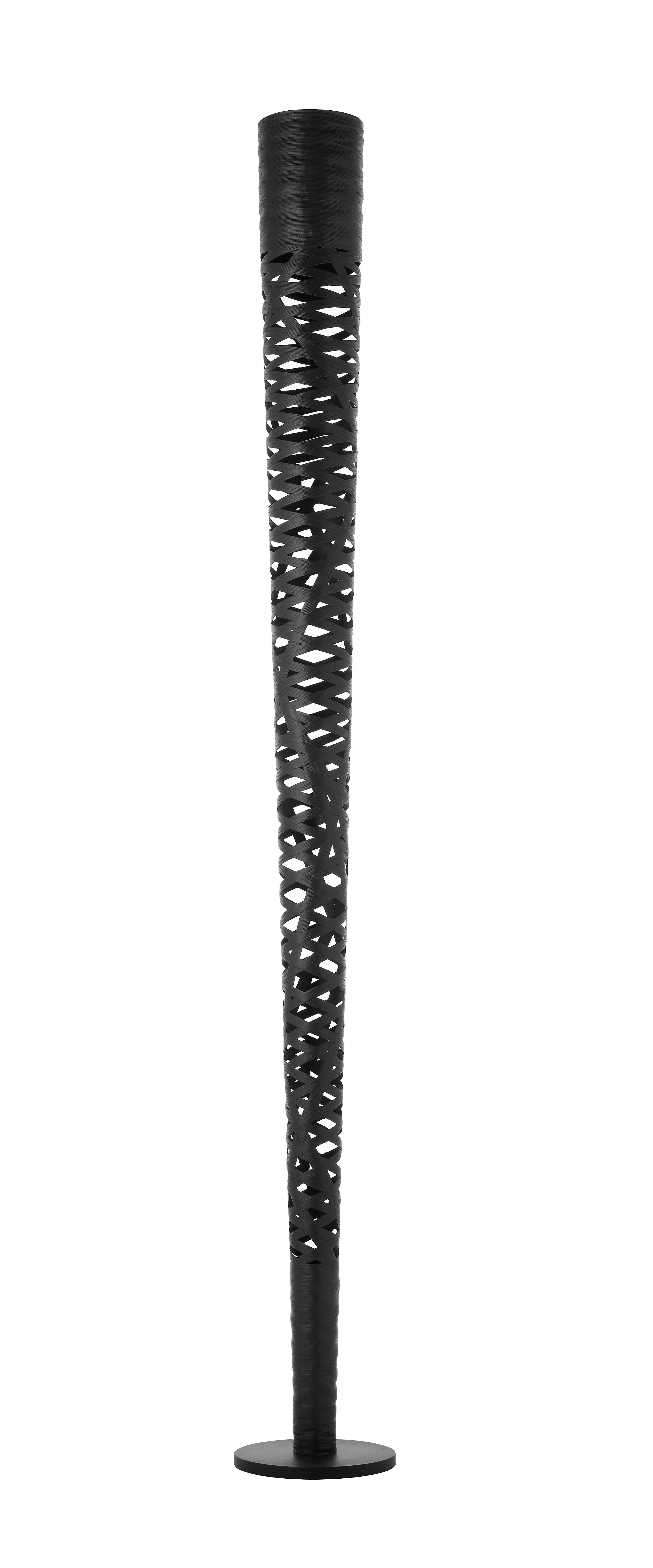 Floor lamp with diffused and indirect light. The fiberglass-based composite material diffuser is produced by modeling tape along a mold with an automatic control of the pitch/pattern, which is then epoxy powder coated. Upper brushed steel parabola