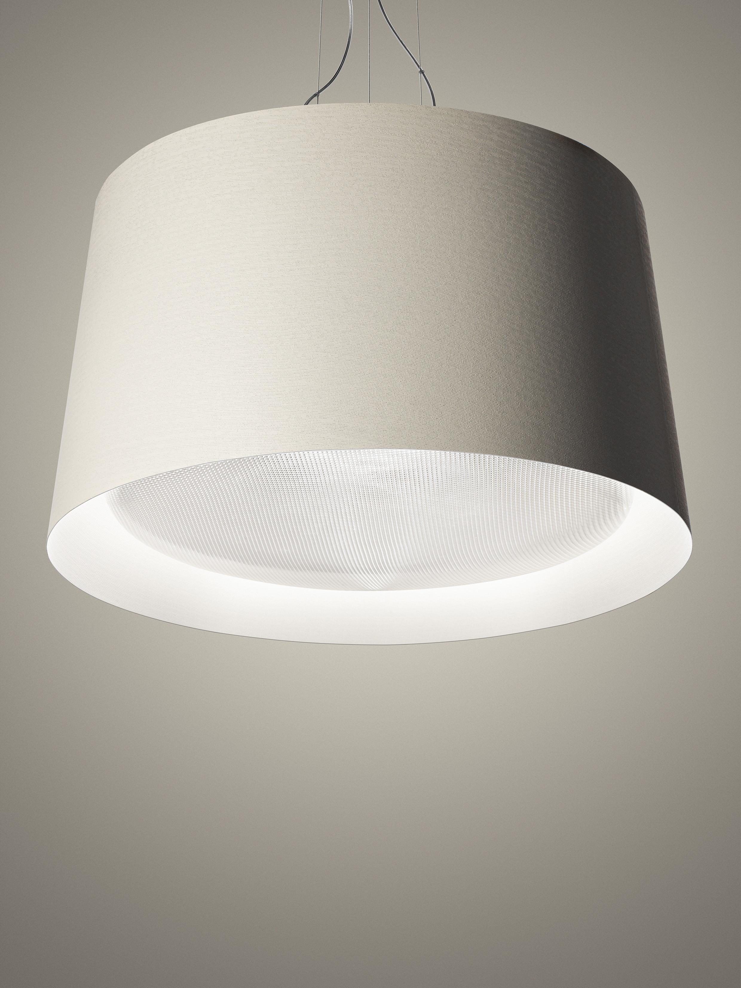 Large suspension lamp with direct and indirect up light. Diffuser made of fiberglass-based composite material and liquid coated. The lamp body consists of a large painted aluminium cone. The diffuser which tops o¬ the cone, where one of the two LED