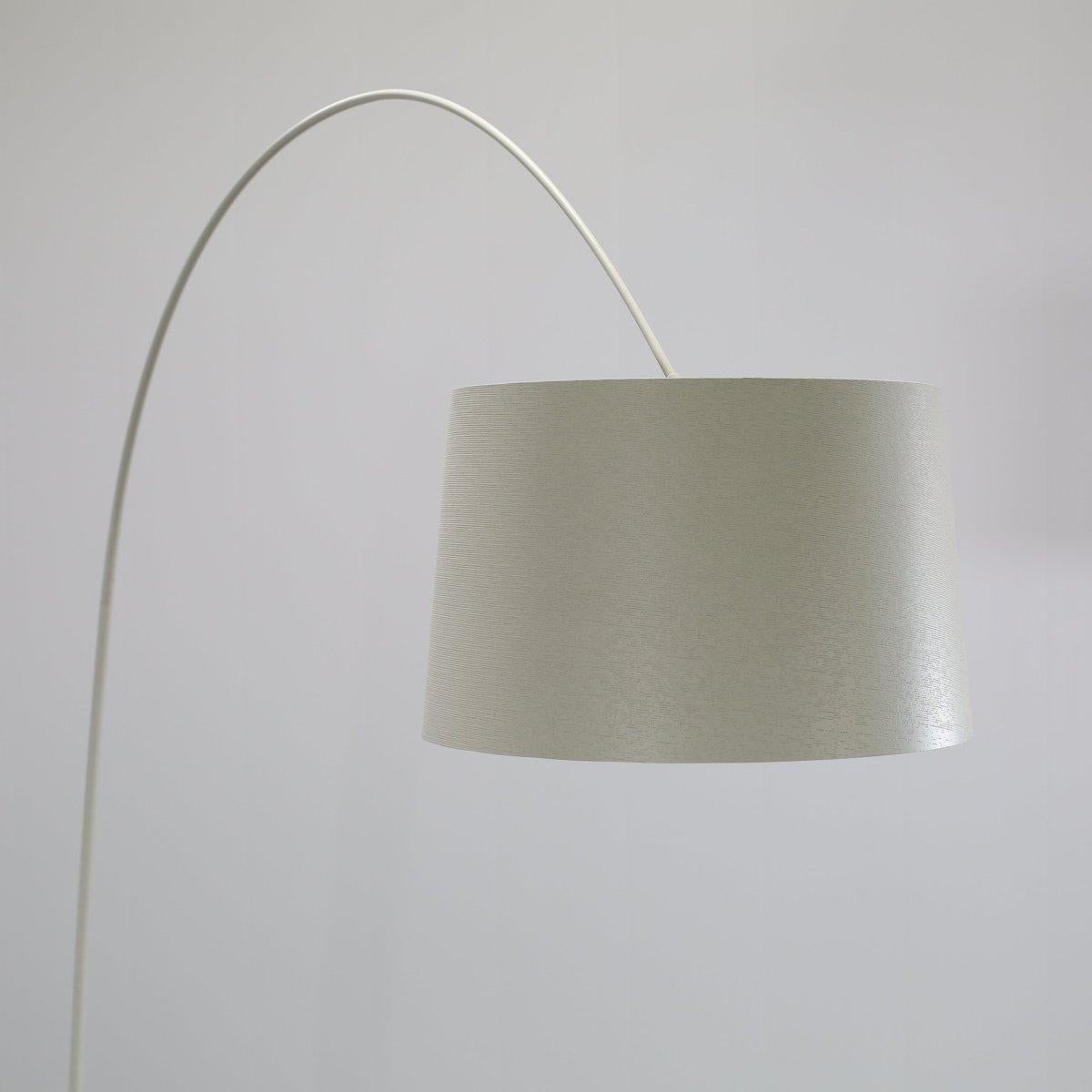 Introducing the stunning Twiggy Floor Lamp by Foscarini, a true statement piece for any modern home. This iconic lamp features a slender stem topped with a large fabric shade that creates a warm and inviting glow. The unique design of the Twiggy