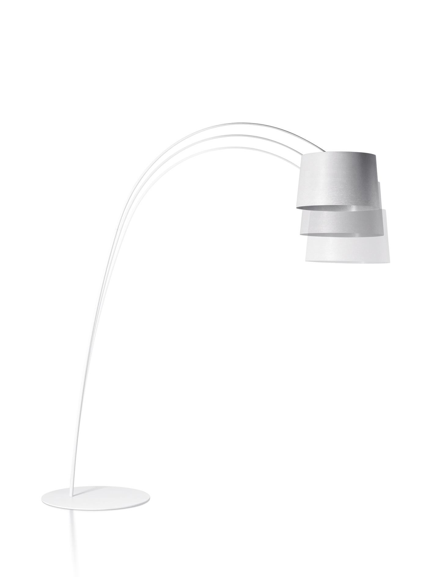 Floor lamp with direct and indirect light. Diffuser and rod made of fiberglass–based composite material and liquid coated. Translucent polycarbonate upper diffuser disc, PMMA lower diffuser disc with polyprismatic internal surface. Epoxy powder