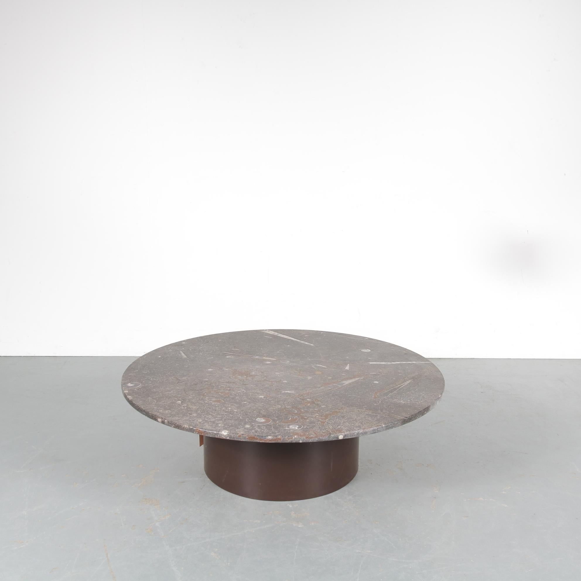 An eye-catching coffee table, designed by Heinz Lilienthal and manufactured in Germany around 1970.

The unique feature of this table is the large round stone top that has ammonite / fossil inlays. This creates a unique appearance that keeps the