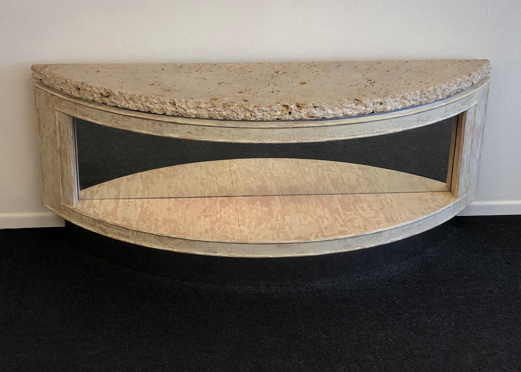 A beautiful 1980s custom design two tier “demilune” console table by Steve Chase. The console was designed for a house in Rancho Mirage. The console is constructed of wood with metal frame to support the heavy 2” fossil shell top, the bottom tier