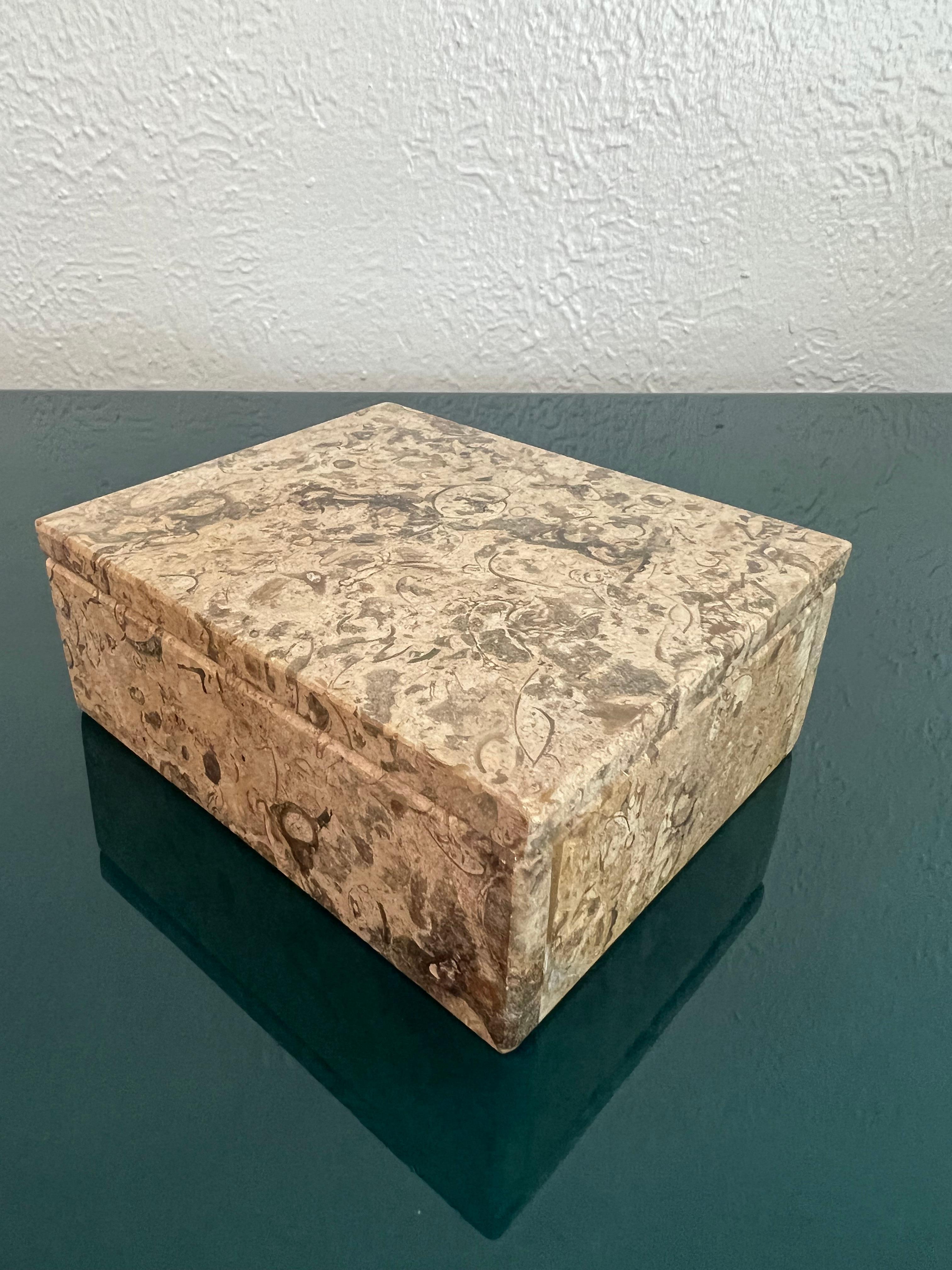 Fossil stone lidded box. 

Would work well in a variety of interiors such as modern, mid century modern, Hollywood regency, etc. Piece blends seamlessly with other designers such as Warren Platner, Paul Evans, Gabriella Crespi, Edward Wormley,