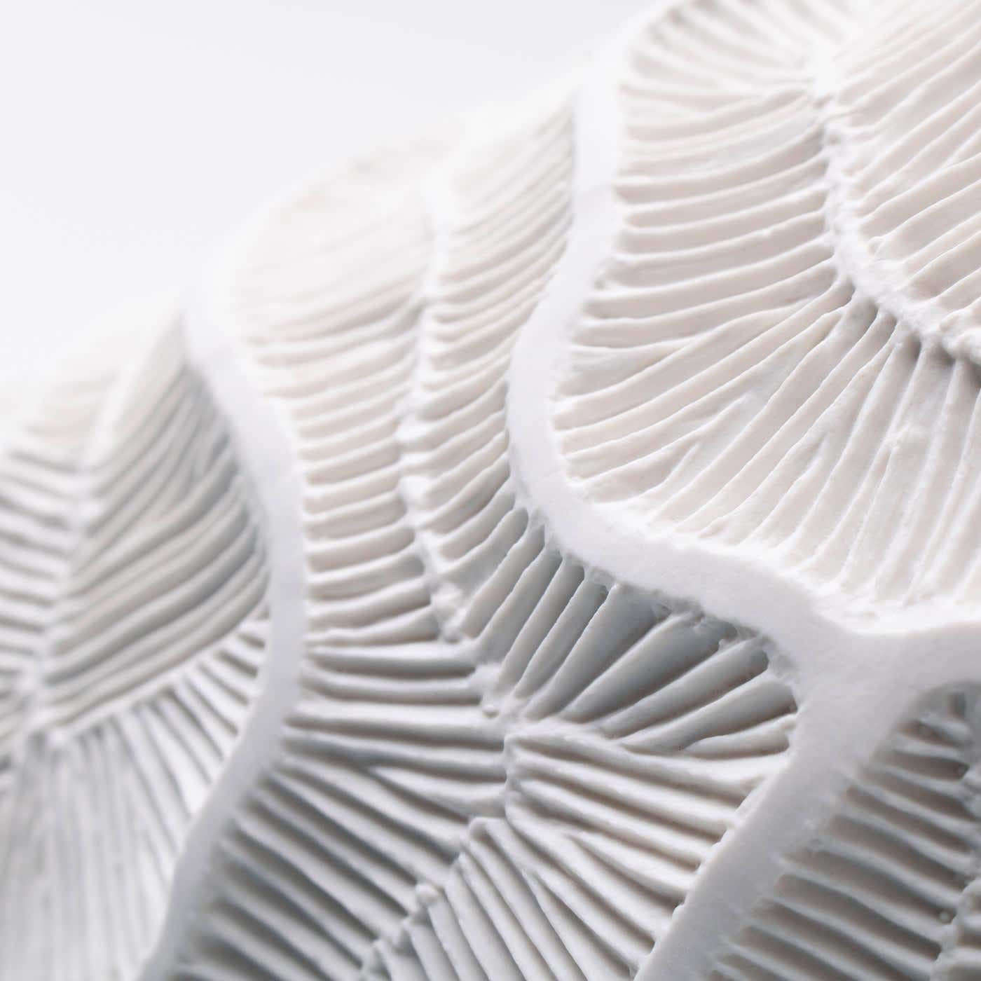 A dense and intricate texture, referring to fossils of madrepores, acts as a skeleton for this vase of Fossilia collection. Featuring beautiful composition, the perfection of shape, and accuracy in the details of the unglazed porcelain, this
