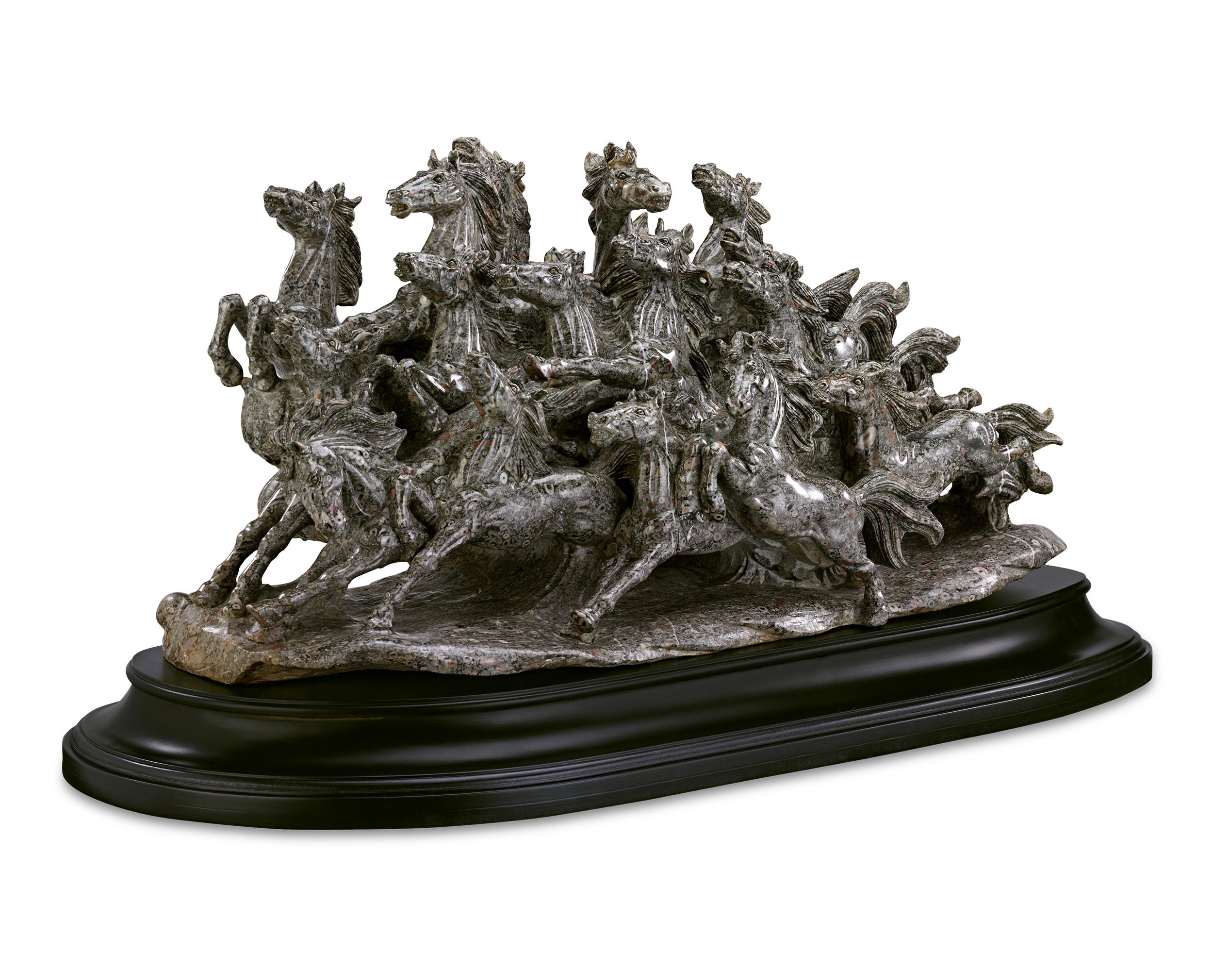 This impressive and unique sculpture transforms a highly rare fossiliferous crinoid marble specimen into a stunning sculpted herd of wild horses. Crafted in the 20th century, the remarkable work features a cacophony of equine animals teeming with