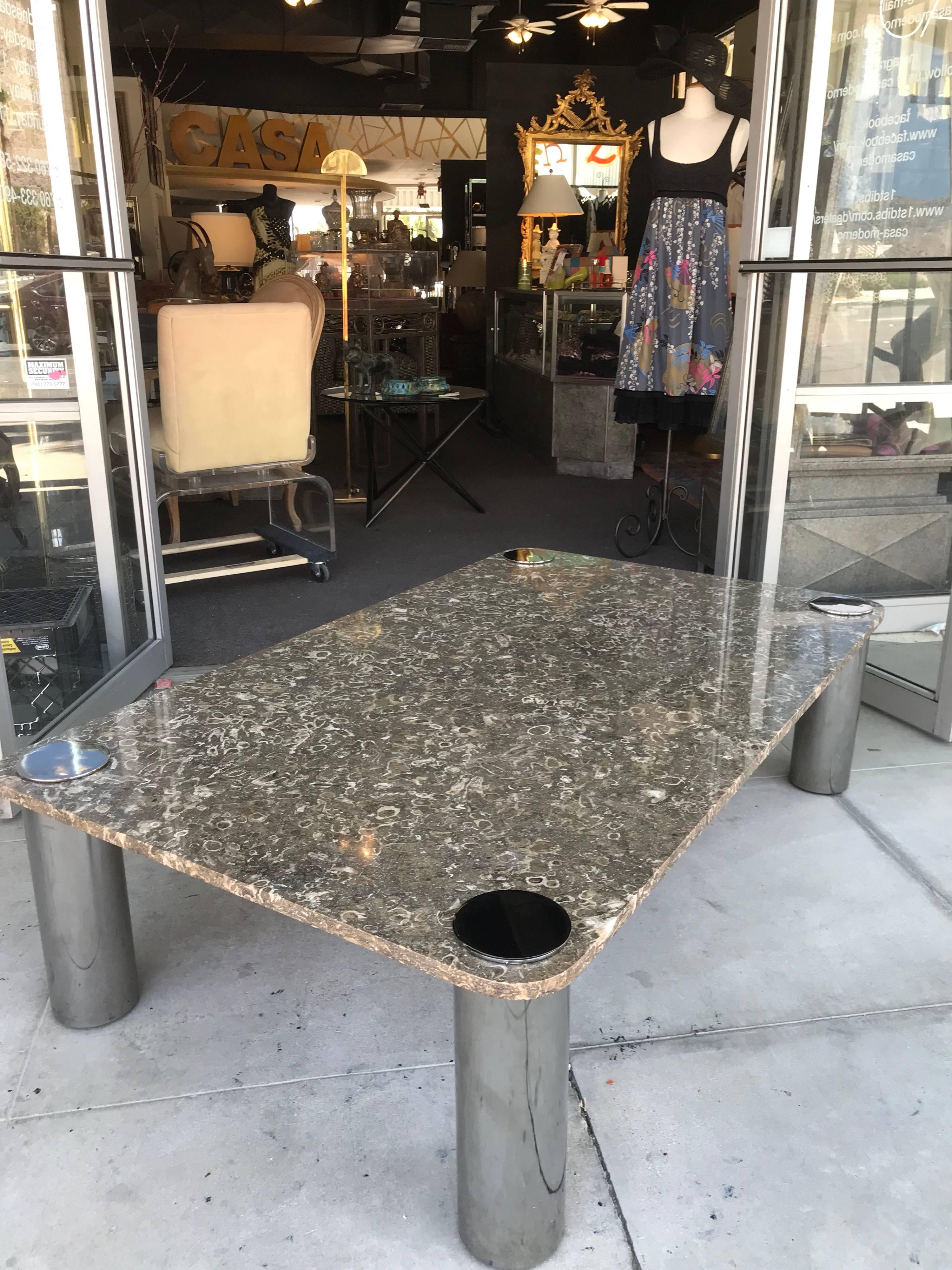 This modern, sexy coffee table was in the living room of a Palm Springs Estate designed by the late, Steve Chase. The entire estate was done in taupe, browns, chrome and Lucite. The top is real stone and looks to be a rare Moroccan Fossil marble in