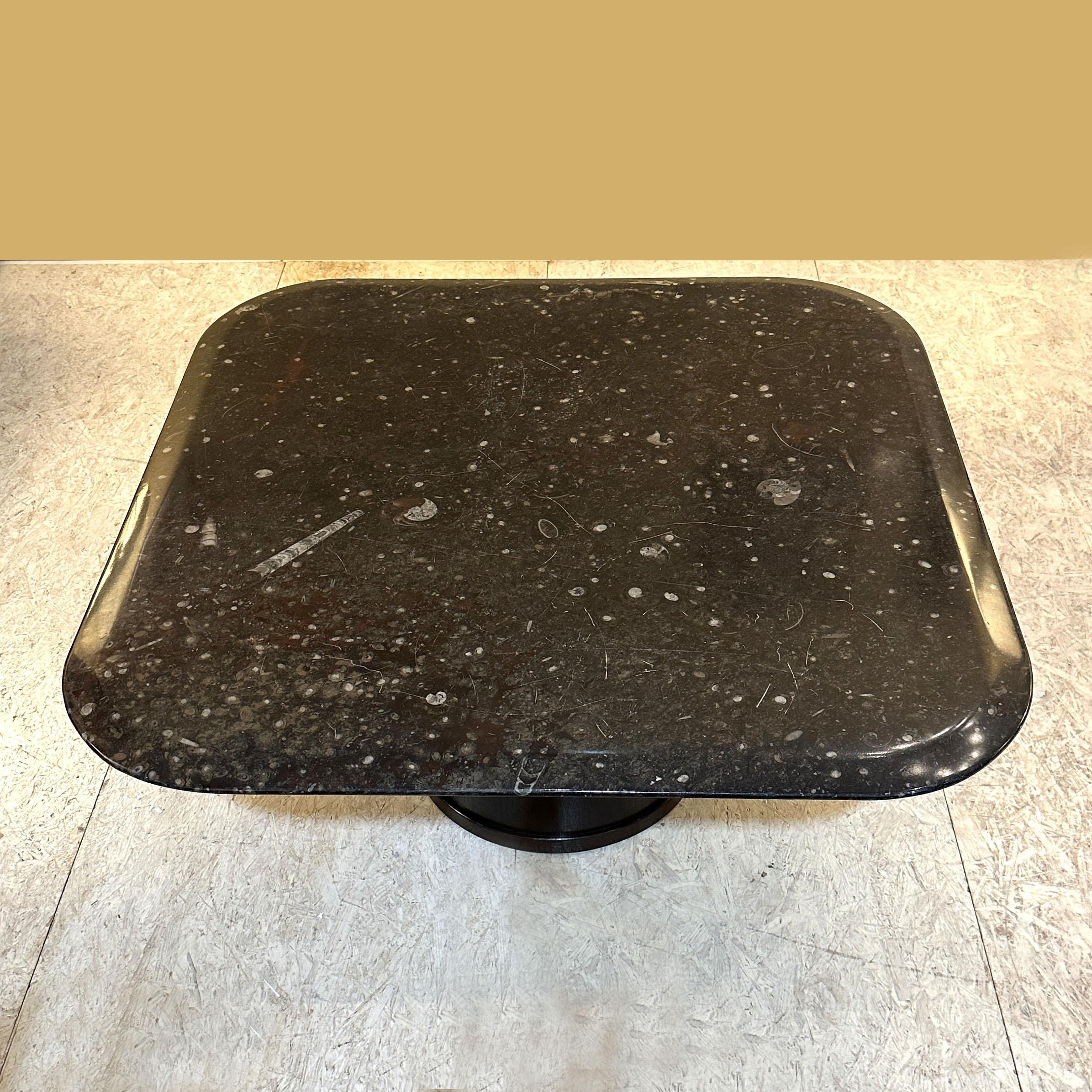 Square fossilized coffee table on round plywood base is designed by the artist Heinz Lilienthal, Germany 1970's. The stone is carved with rounded corners and the edges are chamfered to give the table a soft edge that is in perfect balance with the