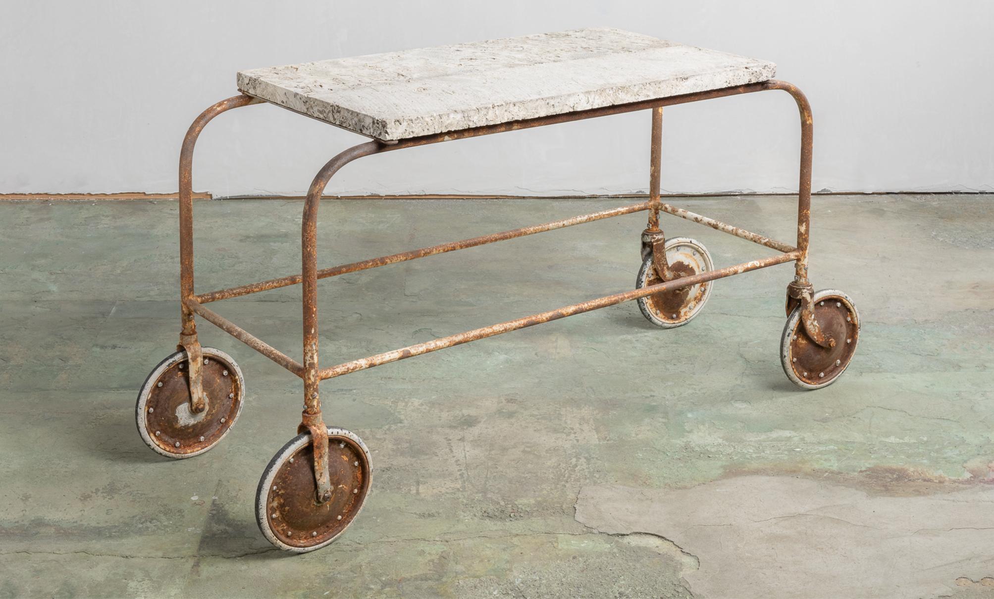 Fossilized stone top green house cart, America, 20th century.

Beautiful rolling cart with thick stone top with embedded fossils, which sits on oversized wheeled legs. Originally from Little Compton, Rhode Island.

This piece ships from