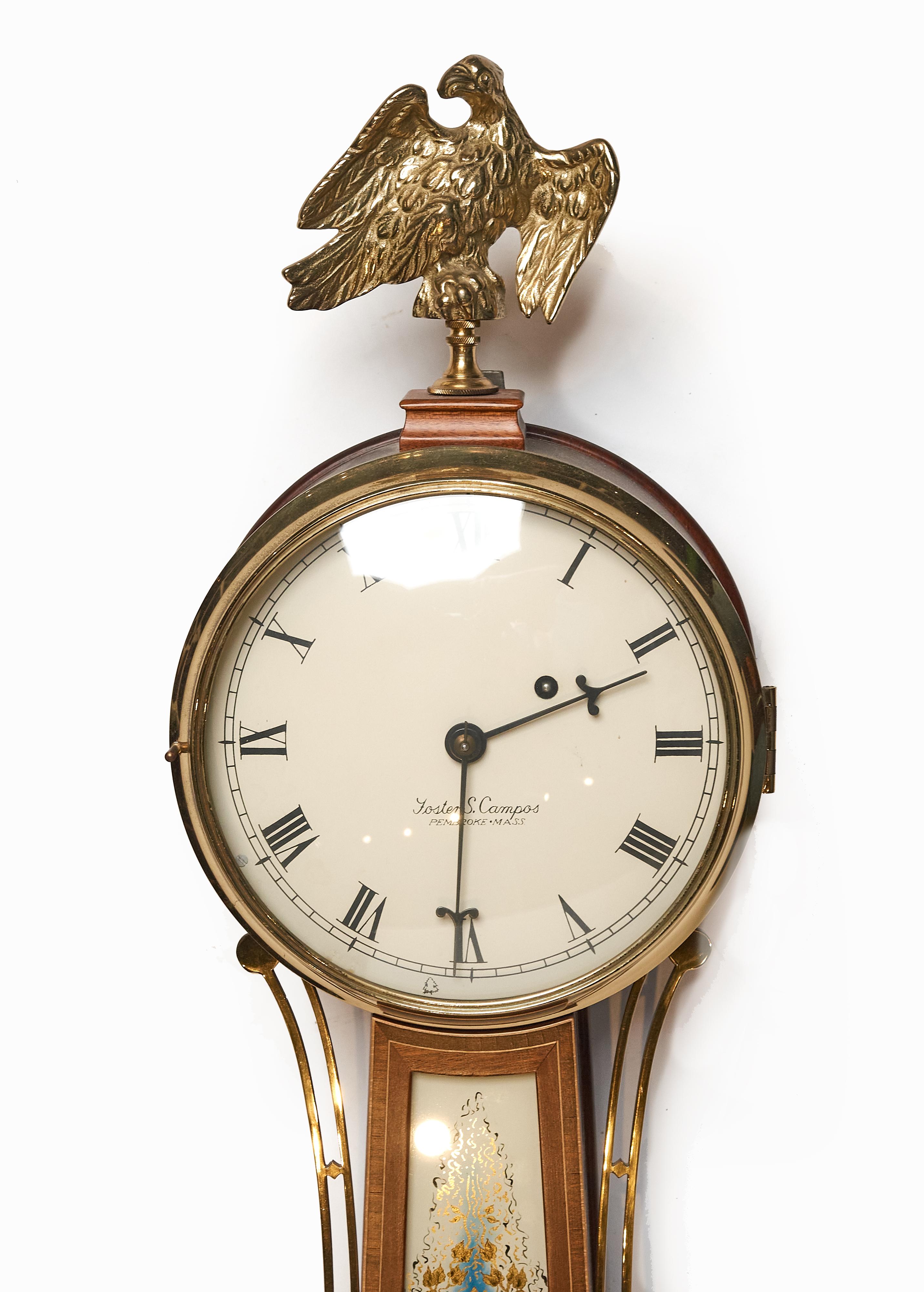 Exquisitely made reproduction banjo clock by one of the masters. Banded mahogany body with signed reverse painted on glass portrait of George Washington and Mount Vernon. the eagle finial is brass.
Foster S. Campos of Pembroke, Mass (1926-2007)was