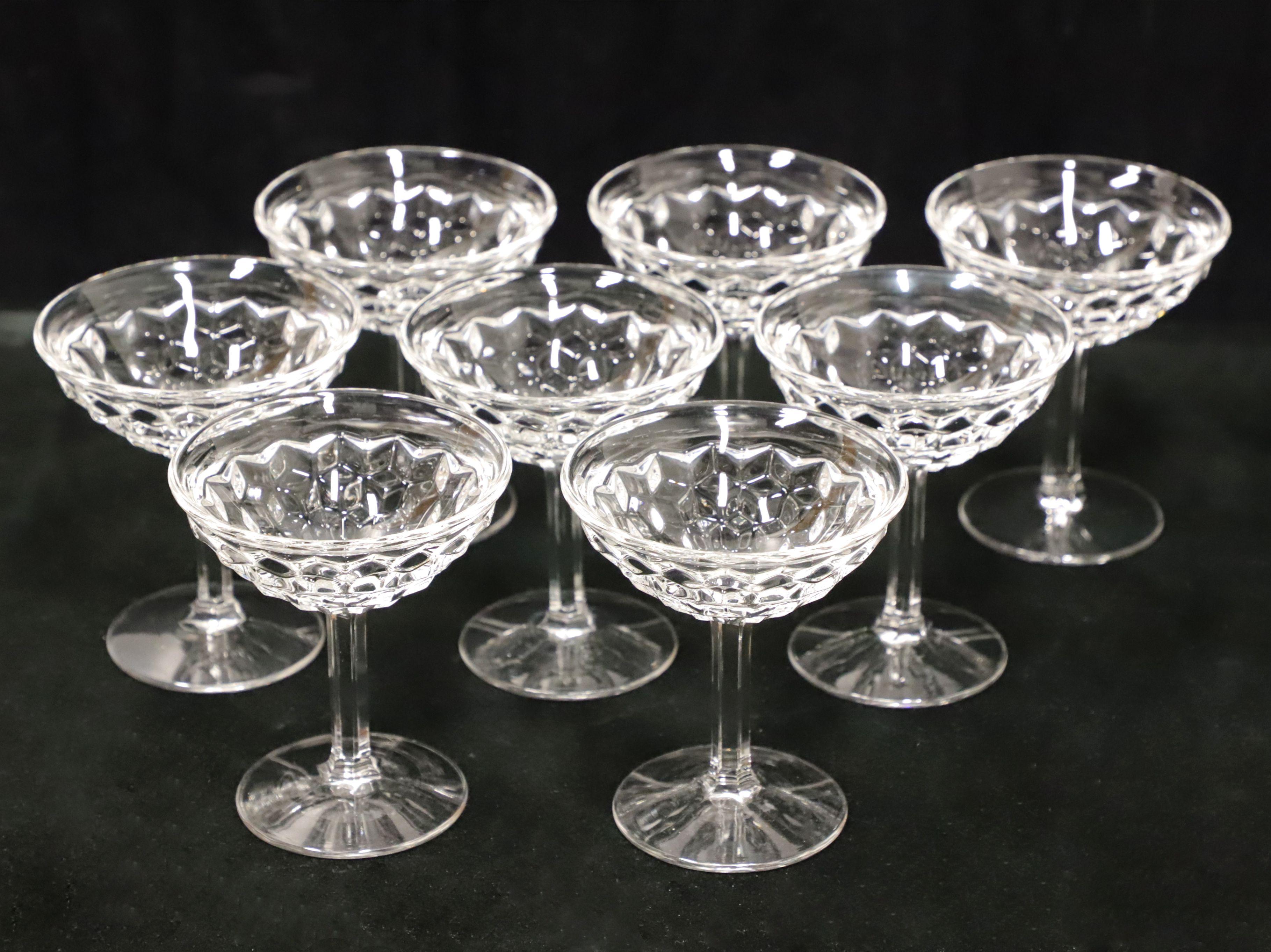 A set of eight sherbet glasses by Fostoria. Each glass has a diamond-like pattern, four inch rim, fluted stem and clear base. Made in the USA, in the mid 20th Century.

Measures: Each Glass: 4w 4d 4.5h, Weighs Approximately: 3 lbs