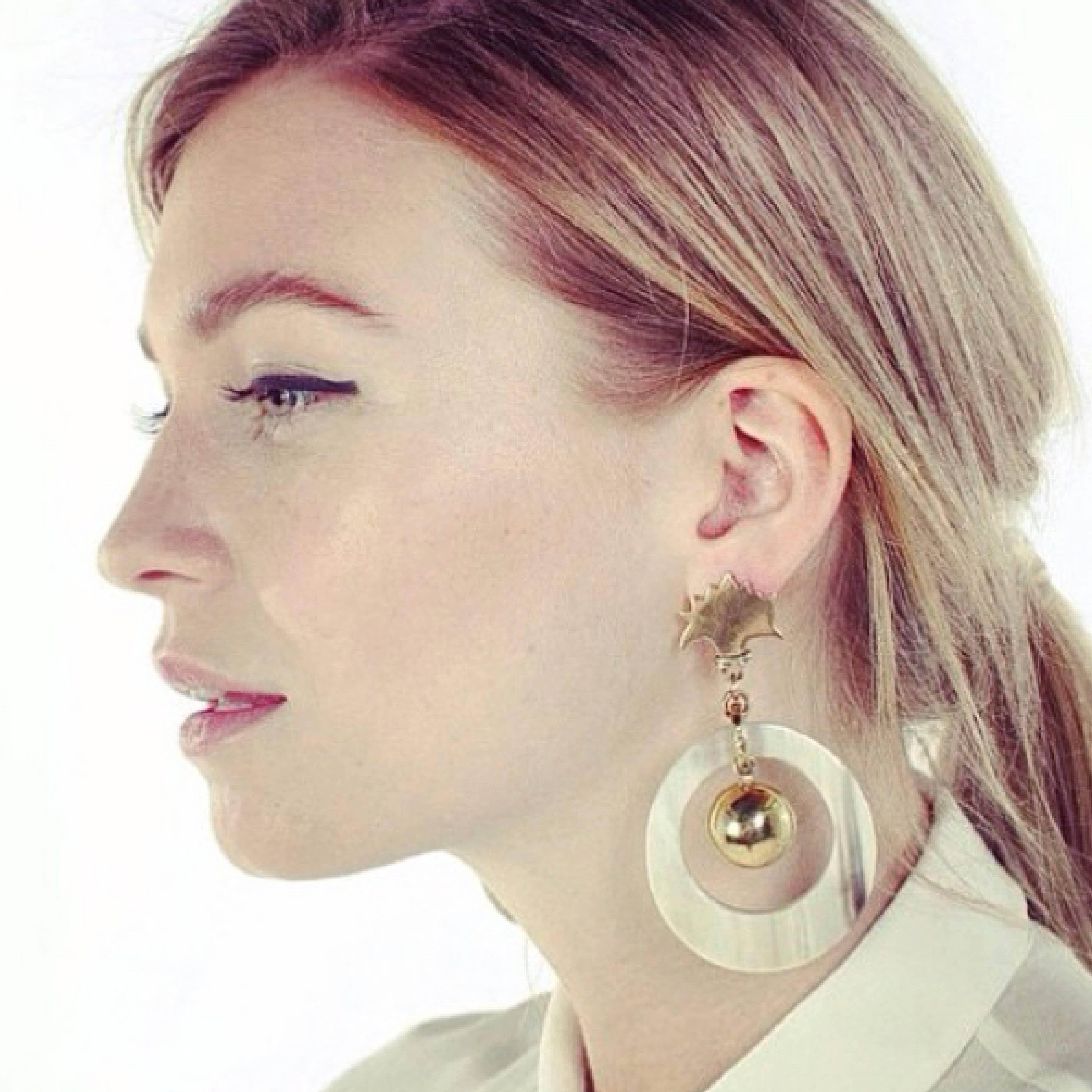 Earrings of African cow horn with art deco motif on ear. 

Fouché earrings are crafted by artisans in Kenya, East Africa, and finished by hand to the finest quality in London. As featured in Vogue. 

Earrings come pierced with solid silver