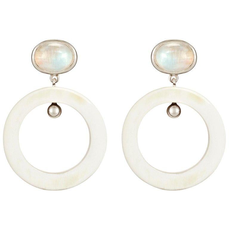 Earrings crafted from African moonstone and cow horn hoops.  

Handmade in London from natural materials with silver pin-backs for pierced ears. Please note that slight horn graining and colour irregularities may occur. 

The Fouché collection is
