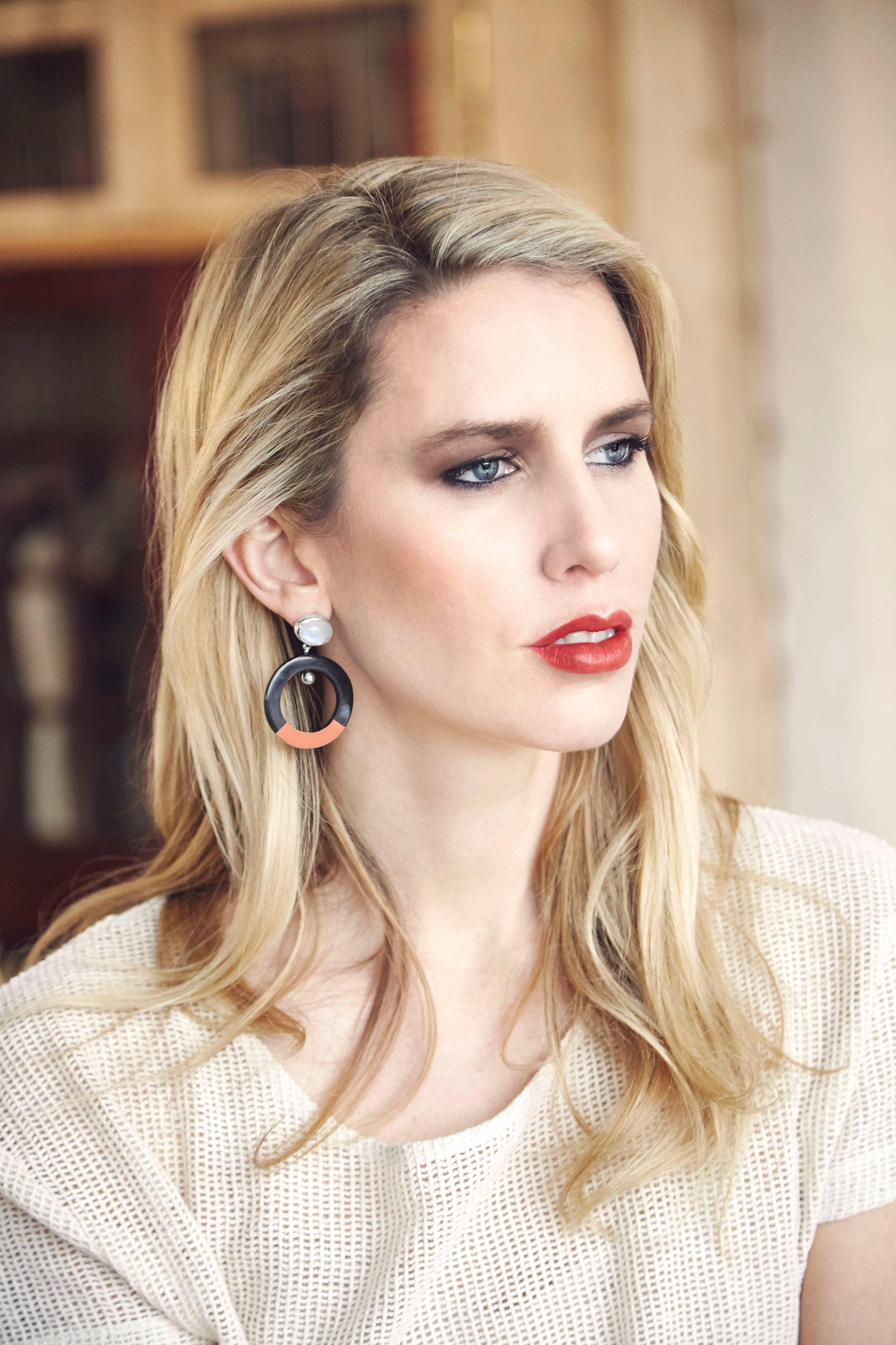 Earrings crafted from African moonstone and cow horn with hand painted coral lacquer enamel. 

Handmade in London from natural materials with silver pin-backs for pierced ears; ready to ship within 2-3 weeks. Please note that slight horn graining