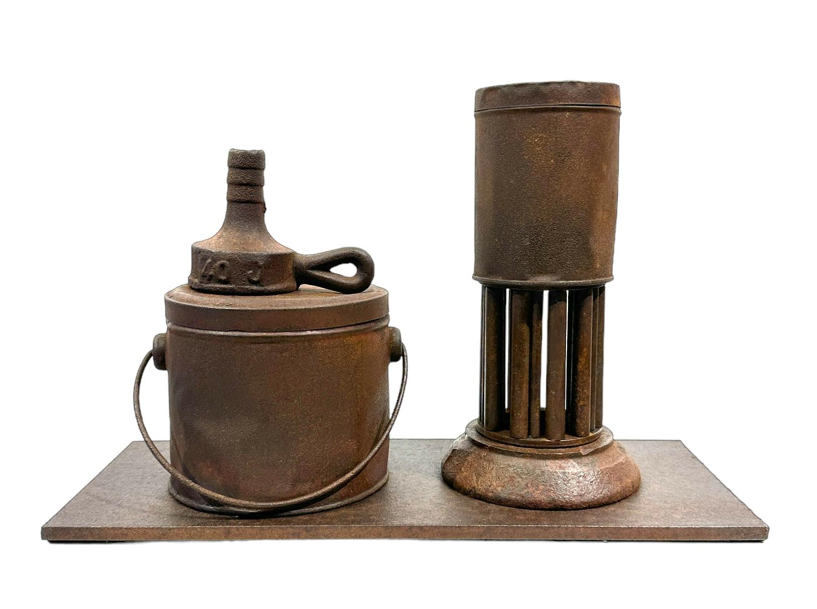 Known for his steel furniture, Jim Rose was an avid collector and scoured salvage yards for unique, interesting items.  Here he has paired various repurposed finds together to create this imaginative sculpture. The rust patinated objects are mounted