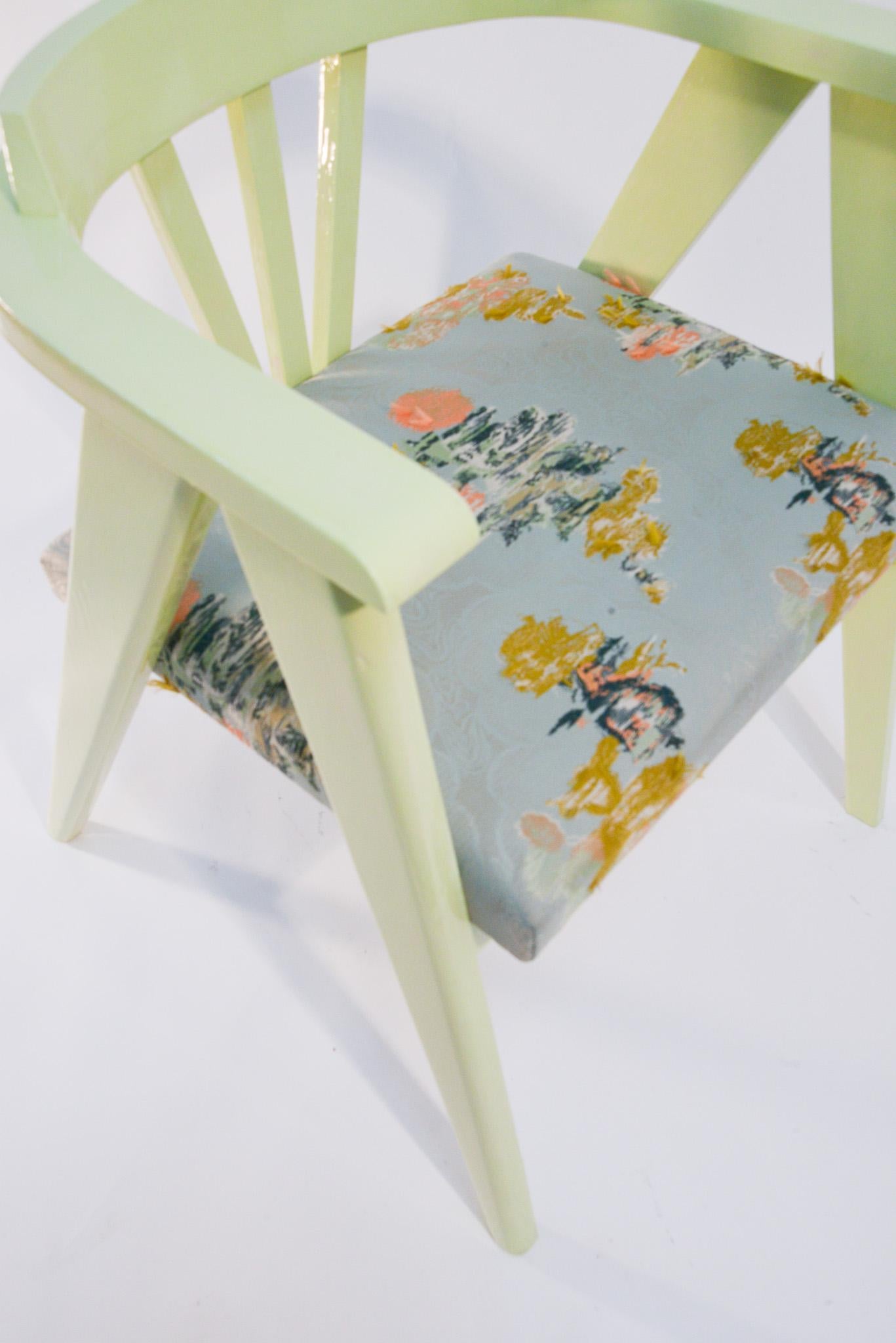 This found chair has a striking wood silhouette and is beautifully crafted. To highlight the form, we newly finished the frame in a mint-green lacquered finish. The seat has been upholstered in a Dedar floral jacquard with a silk wrap and polyester