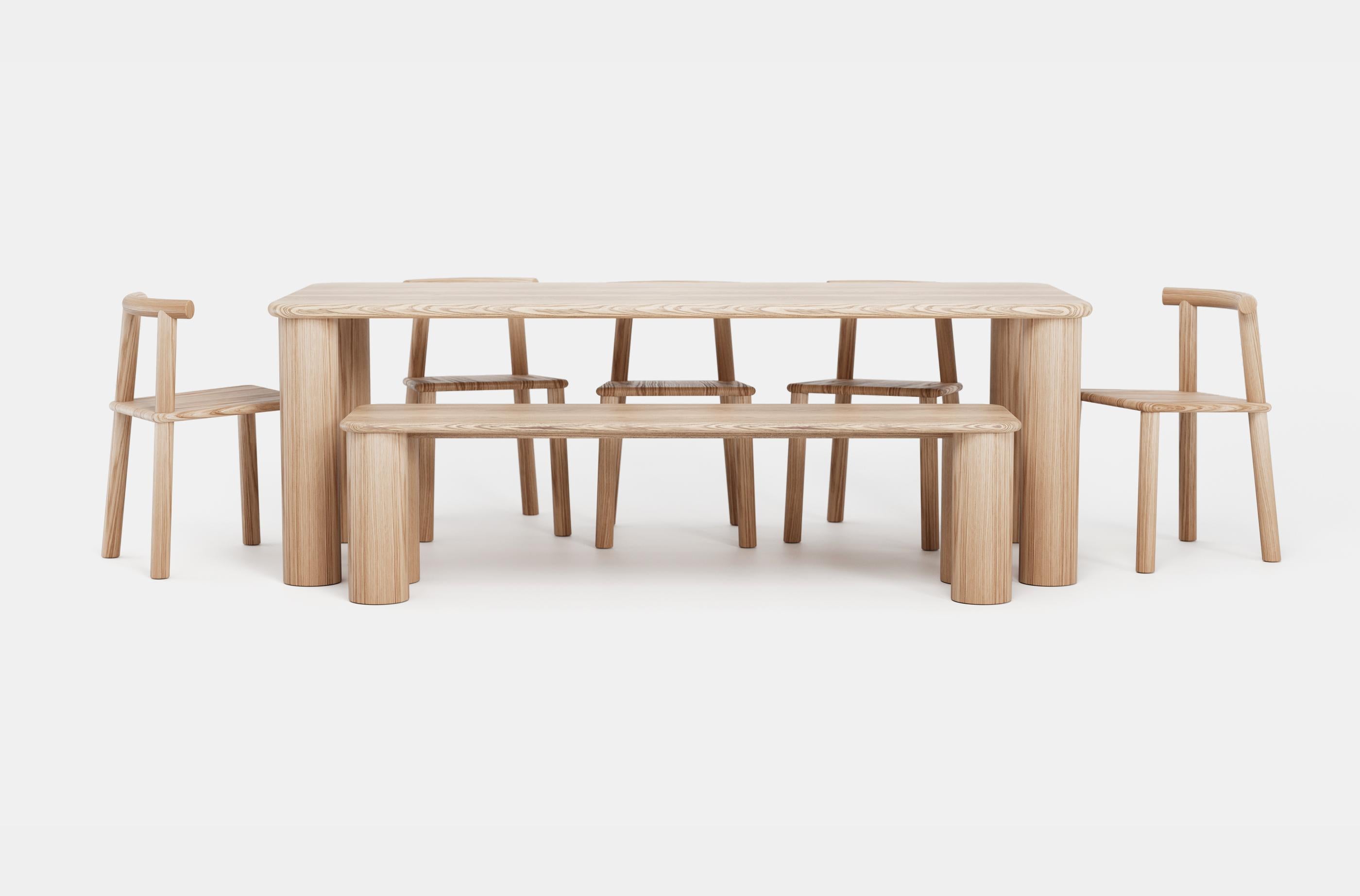 Step into a world of refined elegance and heartfelt connections with the exquisite COMMUNE dining table. Handcrafted from locally sourced red oak, each table is a testament to the natural splendor of Quebec. The sleek, thin tabletop dances in