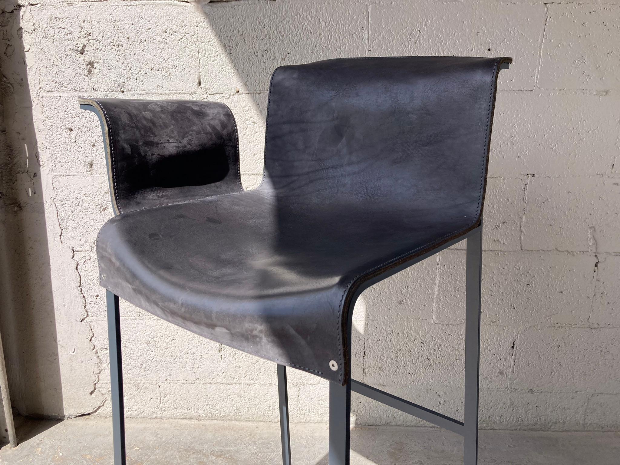 Founded Right Arm Bar Stool Designed by Richard Schipper for Qliv, Saddle Leather and single piece steel frame. Please see our other listings for the stools without arms and left arm stool.These stools do not retail in the US, only available in