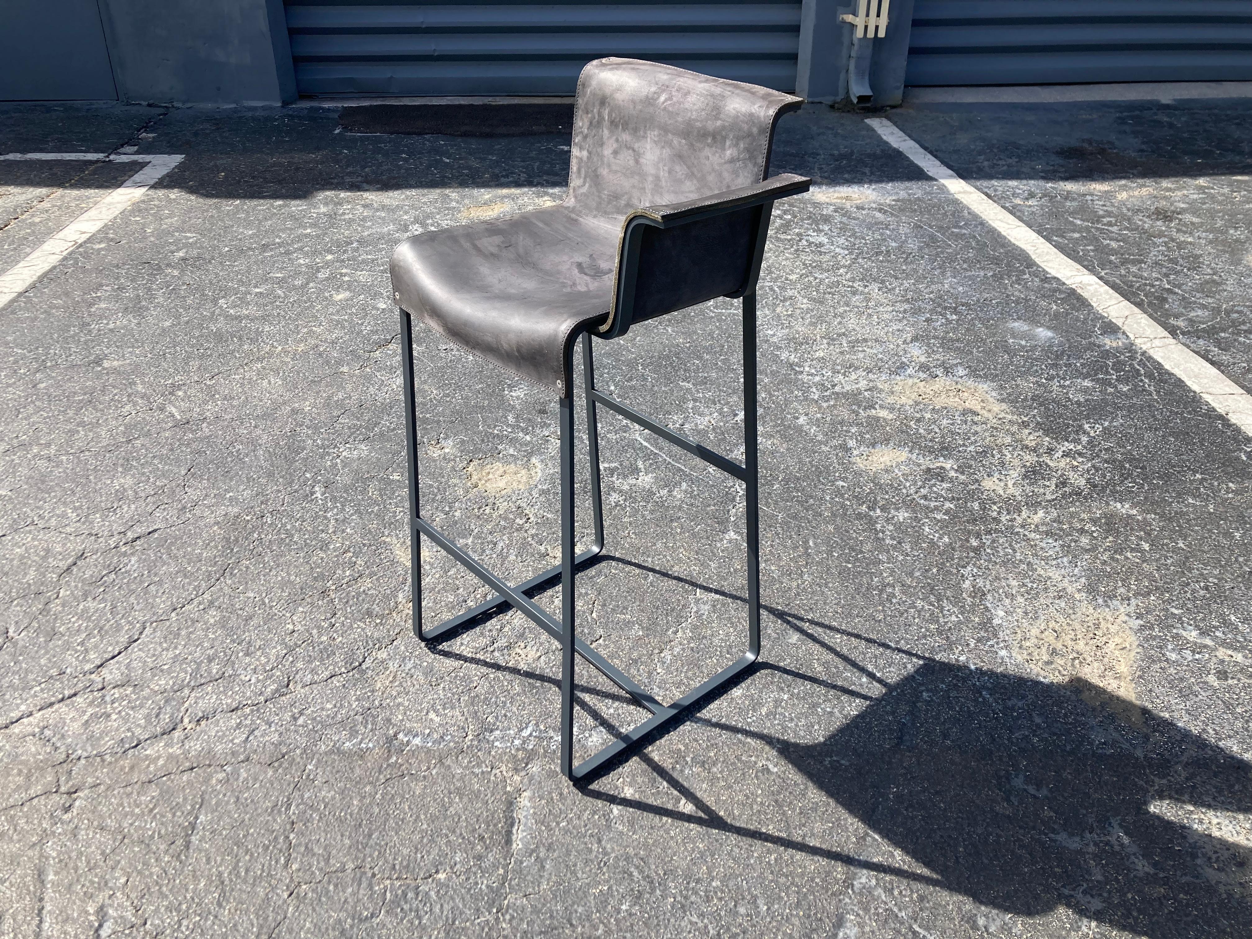 Founded Left Arm Bar Stool  Designed by Richard Schipper for Qliv, Saddle Leather and single piece steel frame. Please see our other listings for the stools without arms and right arm Stool. These stools do not retail in the US, only available in