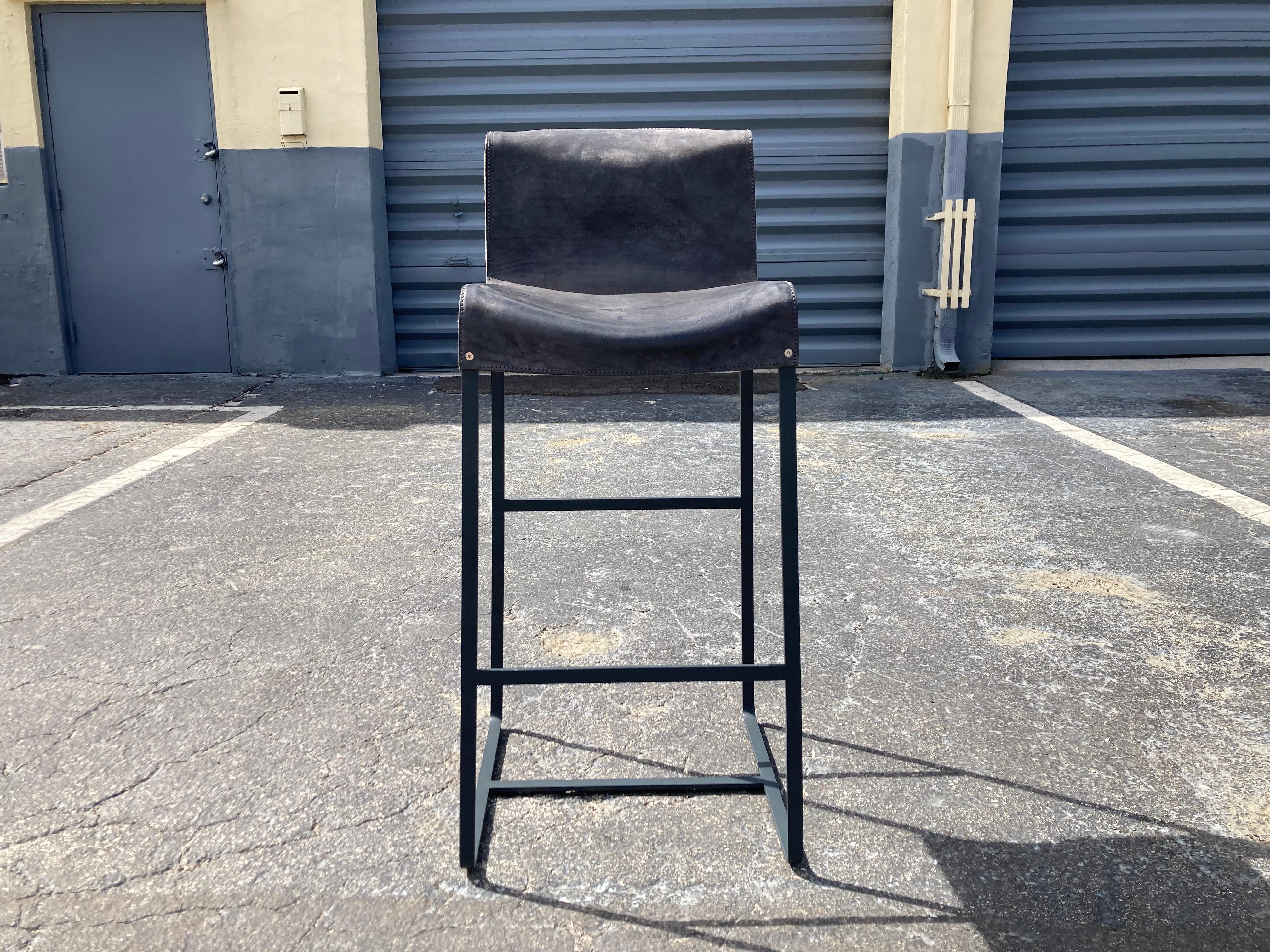 Founded Bar Stools Designed by Richard Schipper for Qliv, Saddle Leather and single piece steel frame. Three without arms available. Please see our other listings for the stools with arms. These stools do not retail in the US, only available in