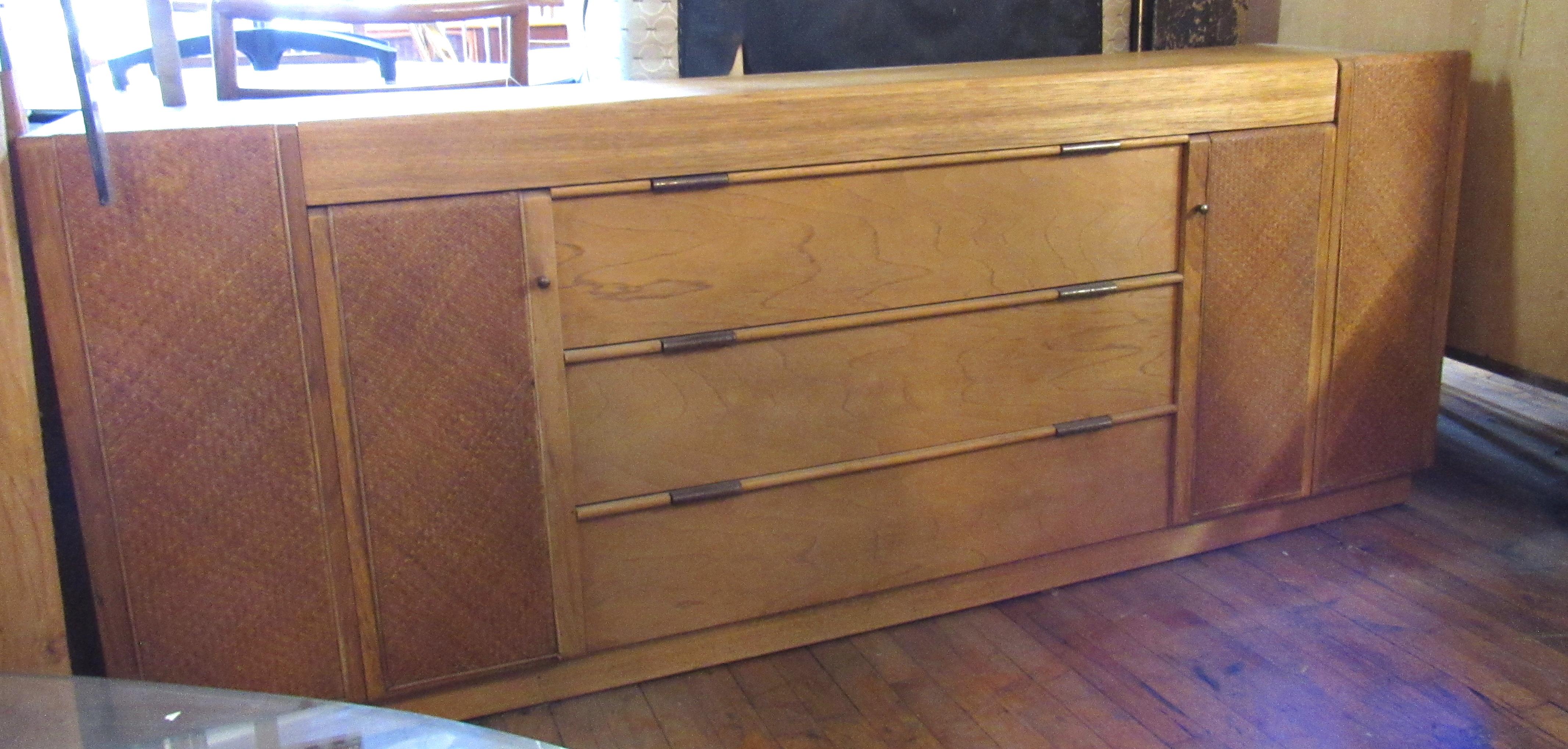 Long dresser with hidden drawers by Founders. Cane wrapped doors and brass hardware.
Please confirm location NY or NJ.