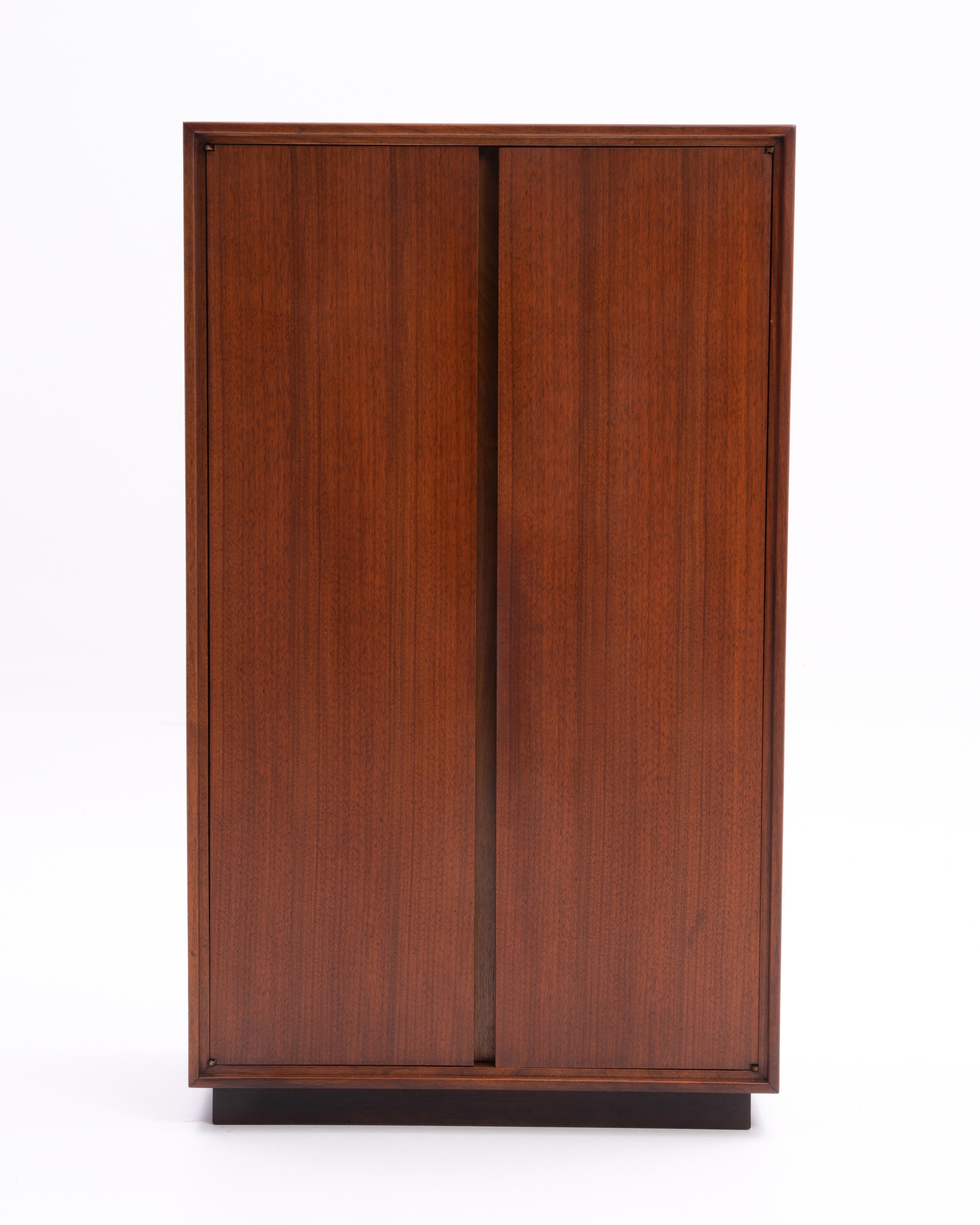 An unmarked walnut cabinet that we are attributing to Jack Cartwright for Founders. The only mark is marked 