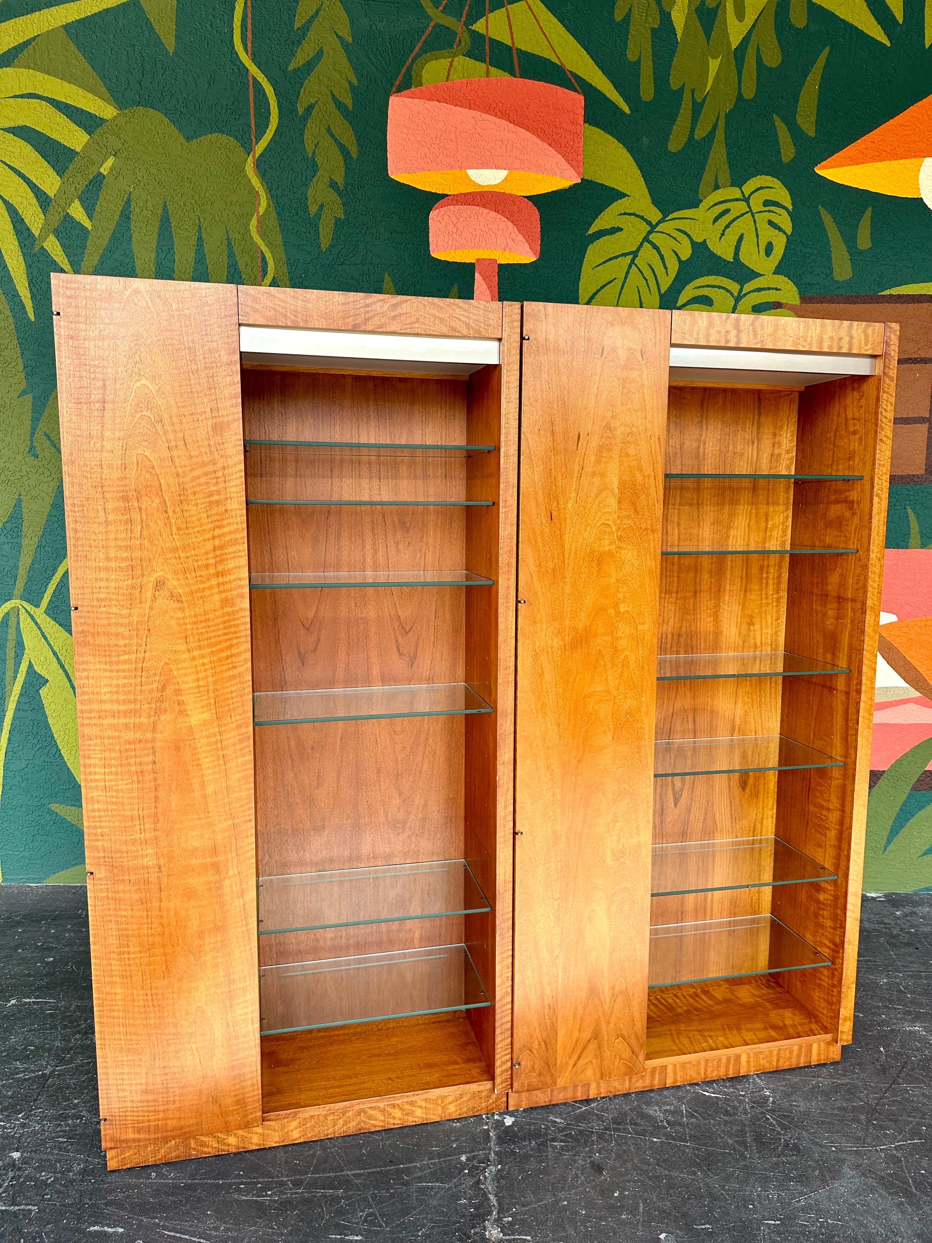 Pair of Mid Century Modern Display/Curio Cabinets by Founders Furniture from the Patterns 23 Collection (see catalog pages in last photo), stamped on back of each cabinet with the model number corresponding to the catalog. Tall wood cabinets with