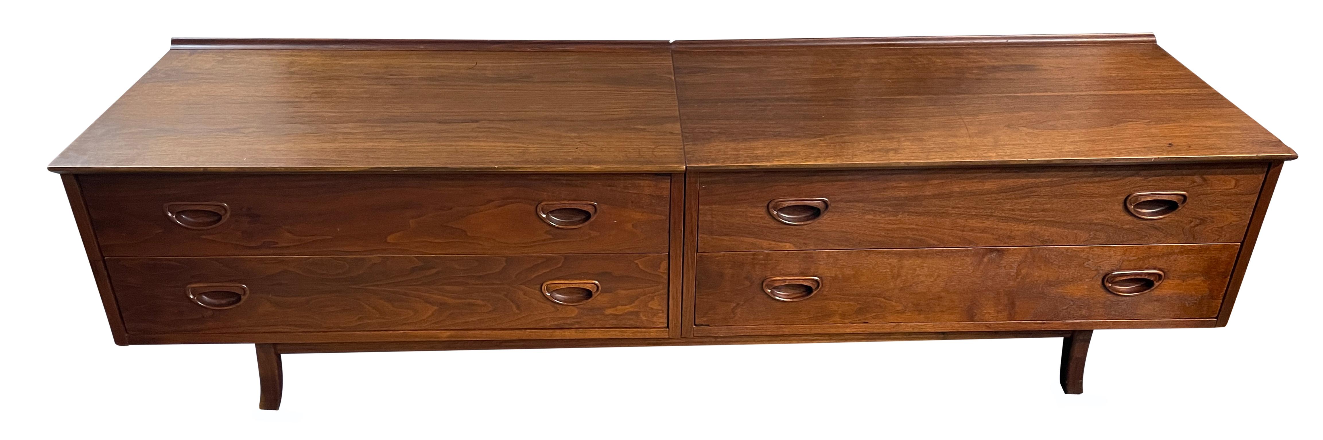 Founders mid-century walnut low 4-drawer dresser credenza carved handles. Very good construction and solid wood drawers. Solid curved wood legs. Has back lip on top surface. Great design and good vintage condition - clean inside and out. Shows