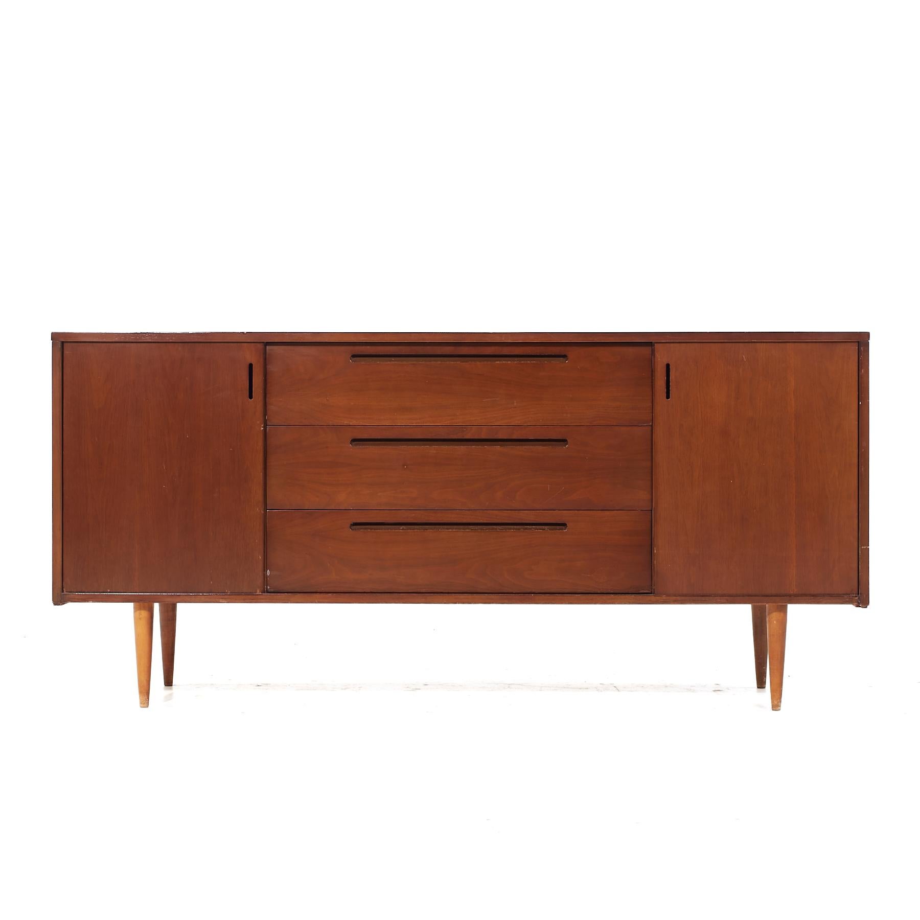 Founders Style Mid Century Walnut Credenza

This credenza measures: 67.75 wide x 17 deep x 31.5 inches high

All pieces of furniture can be had in what we call restored vintage condition. That means the piece is restored upon purchase so it’s free