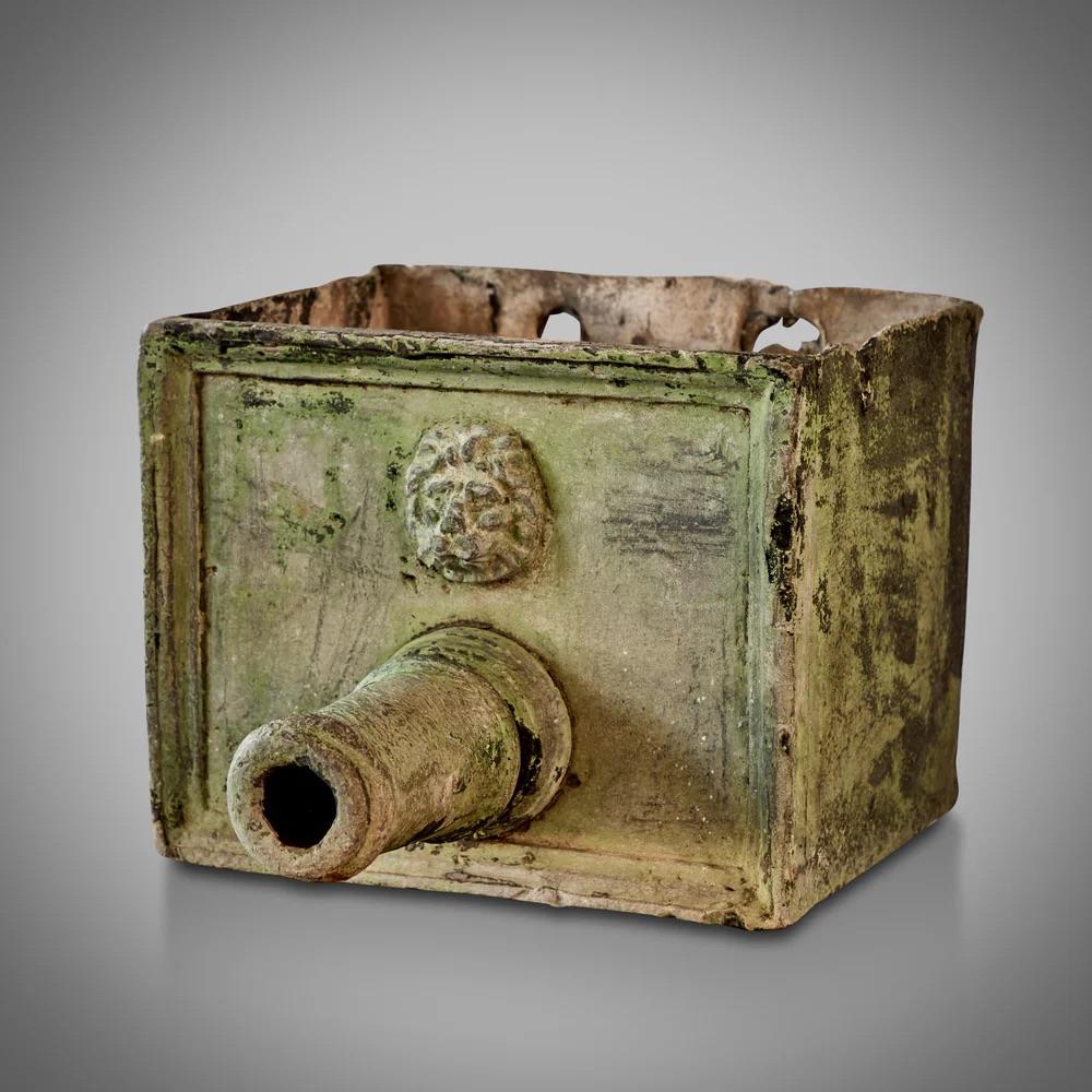 This English fountain head features a stunning verdigris zinc patina and is embossed with a classical lion's head, exuding a sense of antiquity and romance. Its robust and weathered appearance, coupled with historical charm, makes it an enchanting