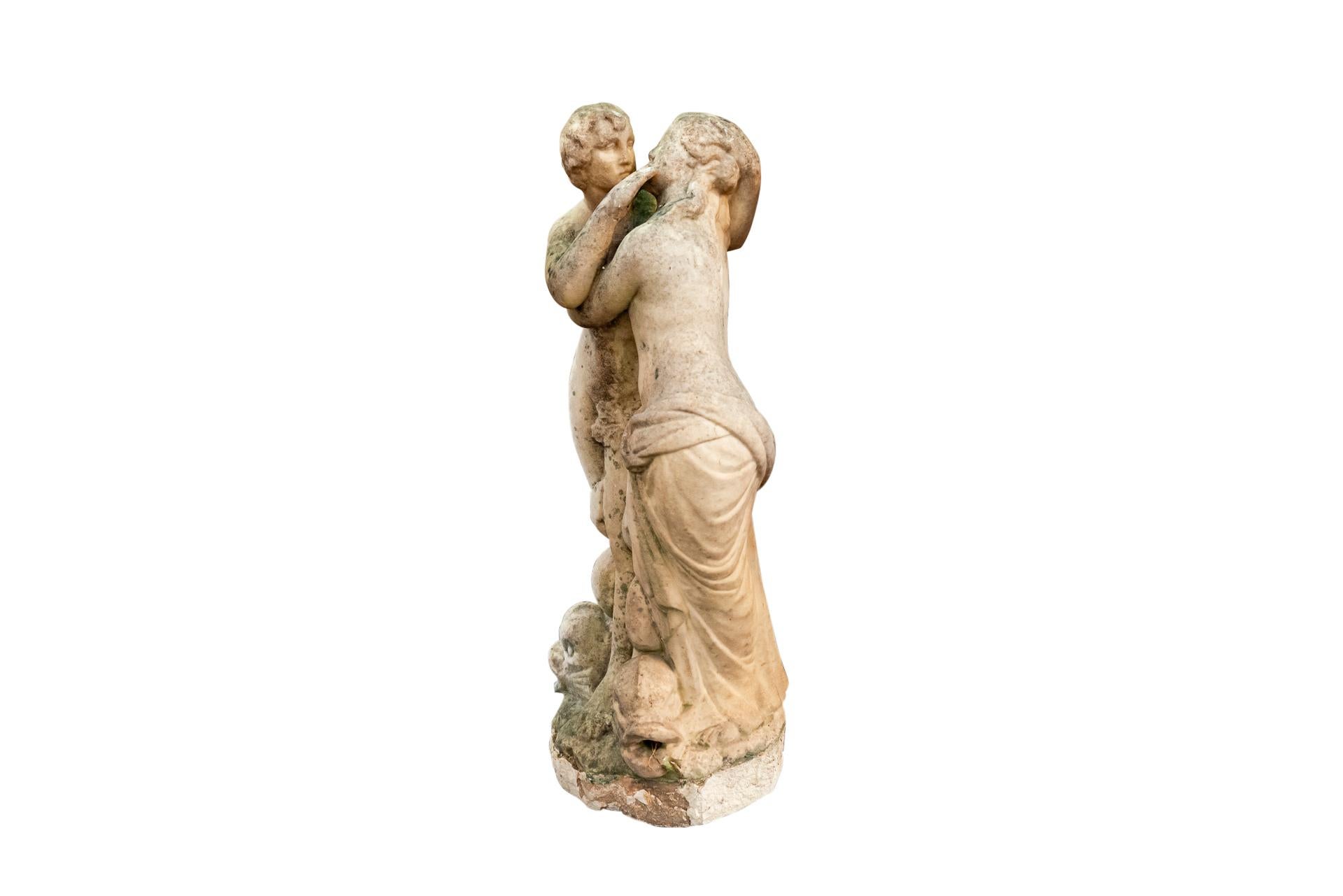 Fountain top with hugging couple appearing from the mouth of three tritons, 
Carrara Marble, 
France, 18th Century.

Measures: Height 71 cm, diameter 27 cm.