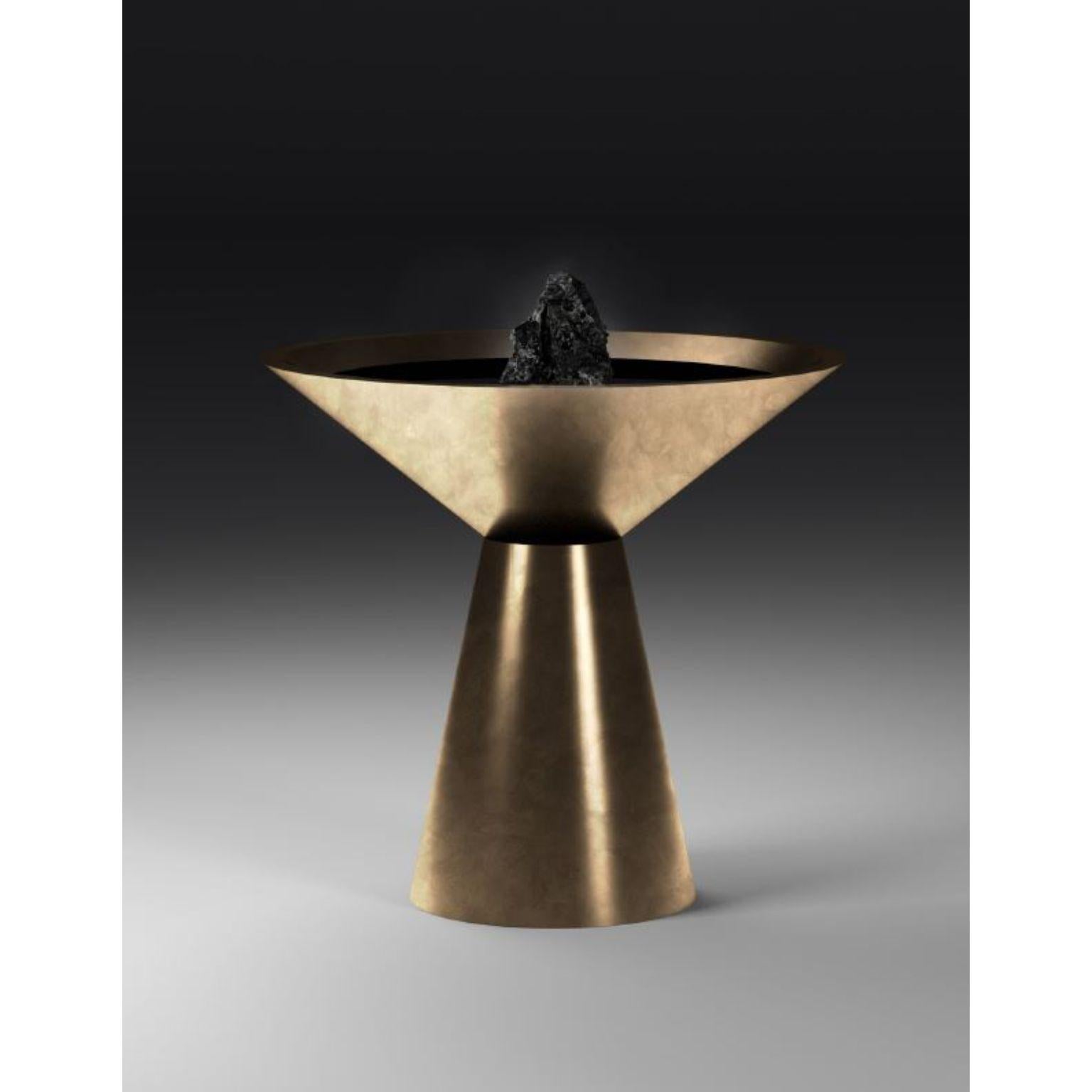 Fountain with Noir Belge by Pierre De Valck.
Dimensions: W 70 x D 70 x H 90 cm.
Materials: Patinated brass with Noir Belge.
Weight: 65 kg.
Each piece is unique.

Pierre De Valck (1991) born in Brussels, is a Ghent-based designer with a