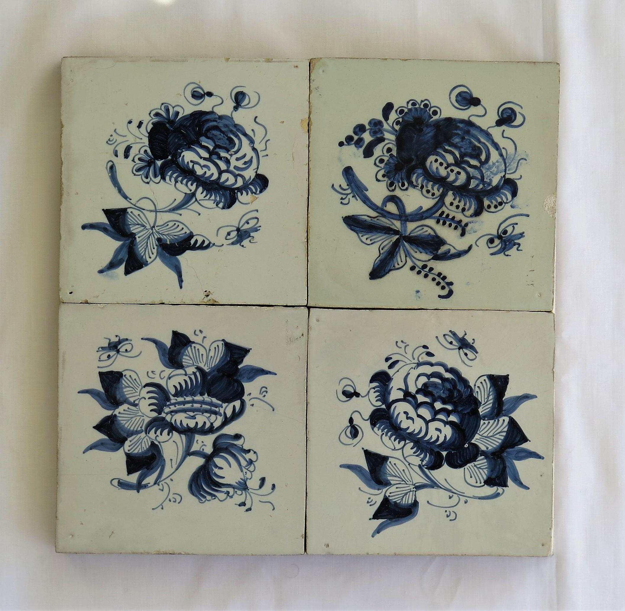 These are Four Delft ceramic wall tiles mounted on a modern wood frame, all with a blue and white hand painted flower pattern, made in the Netherlands during the 17th century, circa 1680.

Each tile is nominally 5 inches square with the display