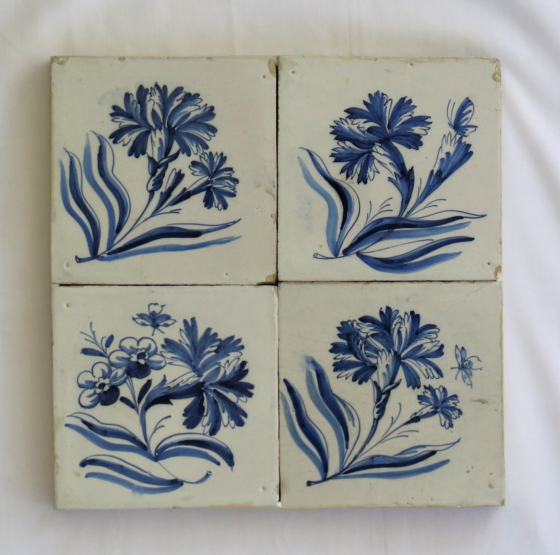 These are Four Delft ceramic wall tiles mounted on a modern wood frame, all with a blue and white hand painted flower pattern, made in the Netherlands during the 17th century, circa 1680.

Each tile is nominally 5 inches square with the display