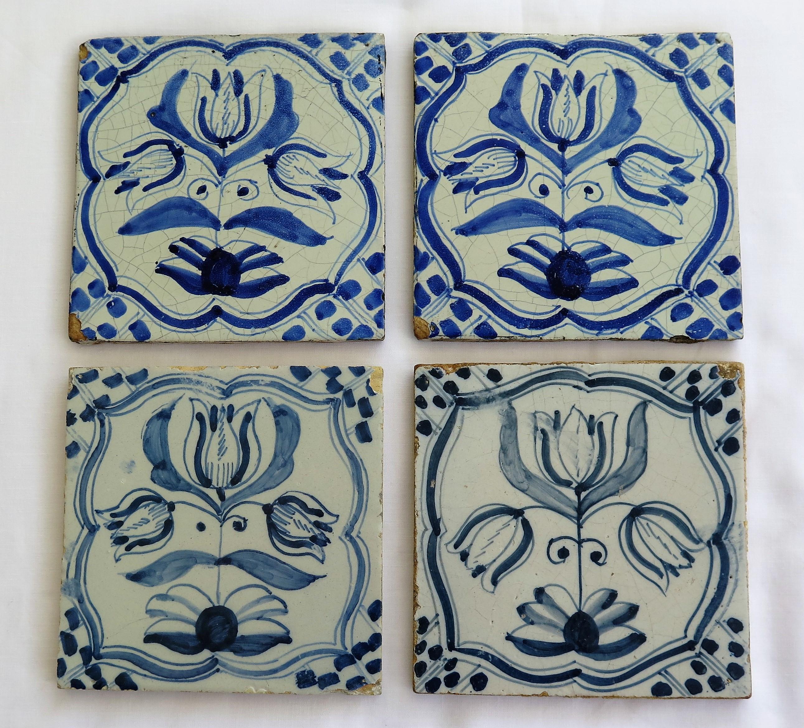 These are FOUR Delft ceramic Wall Tiles, all with a blue Tulip pattern, made in the Netherlands during the 17th century, circa 1680. 

The tiles are nominally 5 inches square and just under 3/8 inches thick.

All four tiles are unique, being