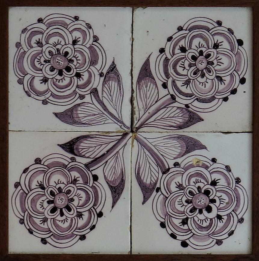 These are four matching delft earthenware tiles, all with a manganese Frisian Rose pattern and located in a hardwood frame, the tiles made in the Netherlands during the 18th century, circa 1760. 

The tiles are nominally 5 inches square and 5/16