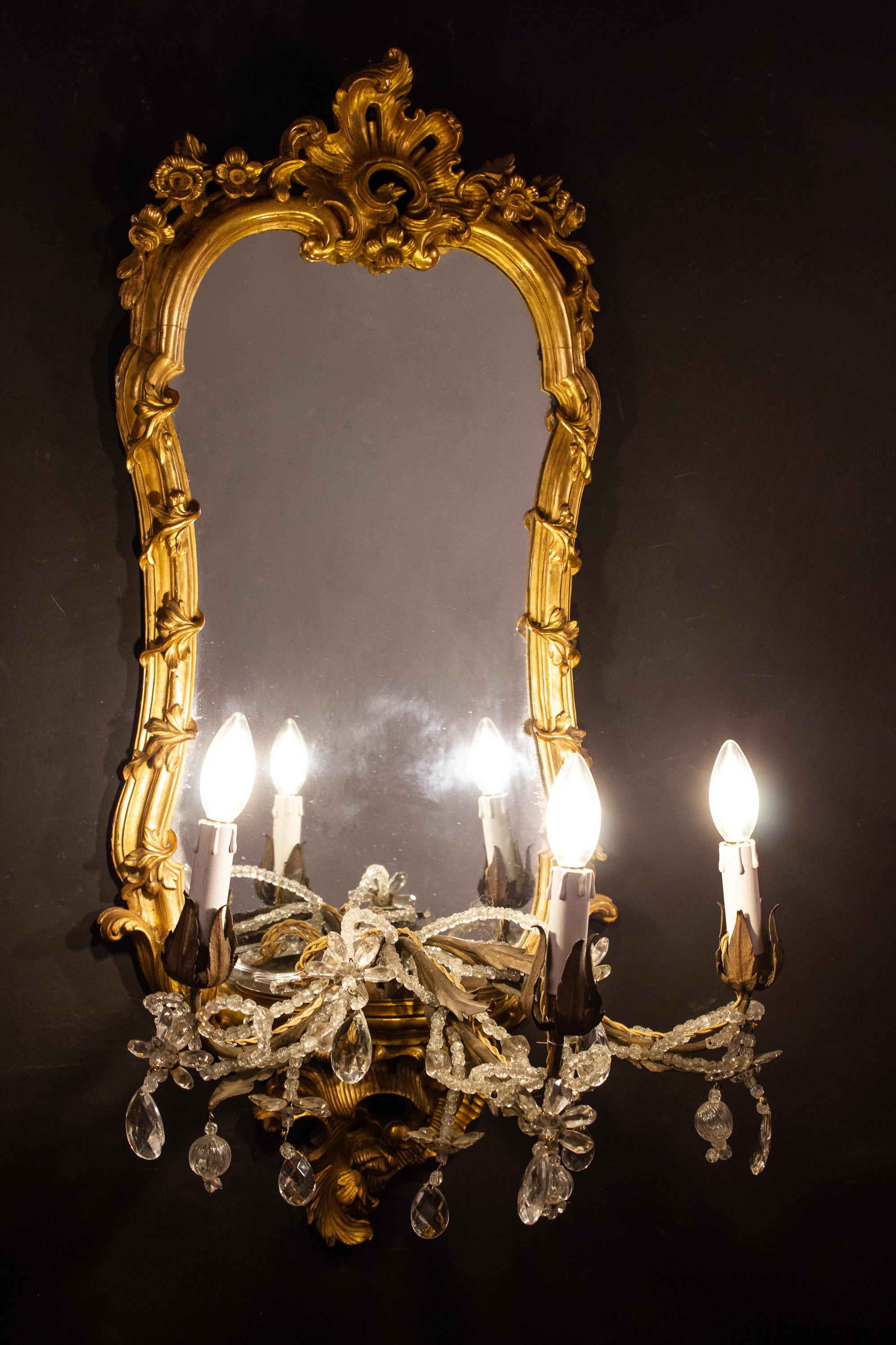 Wonderful rare set of four 18th century finely carved and giltwood mirrors with three candle arms. Roma, 1750.
 The Candle arms can also be removed and used as a base for a vase or porcelain sculpture .
 Original gilding in very good