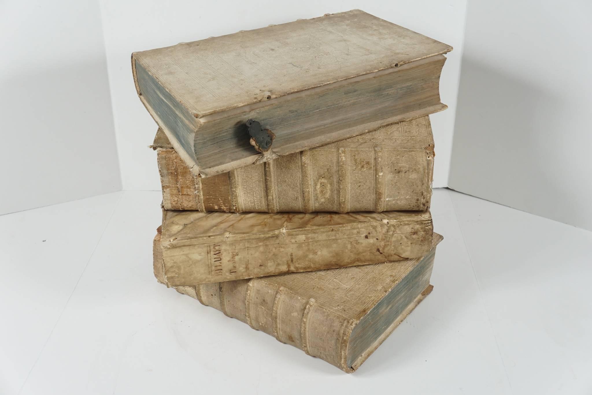 These four books printed in Latin are covered in beautiful old vellum covers and spines. Each book contains text, margin commentary and pictorial illustration to the fronts pages. All but one is from the same library with like beautifully embossed